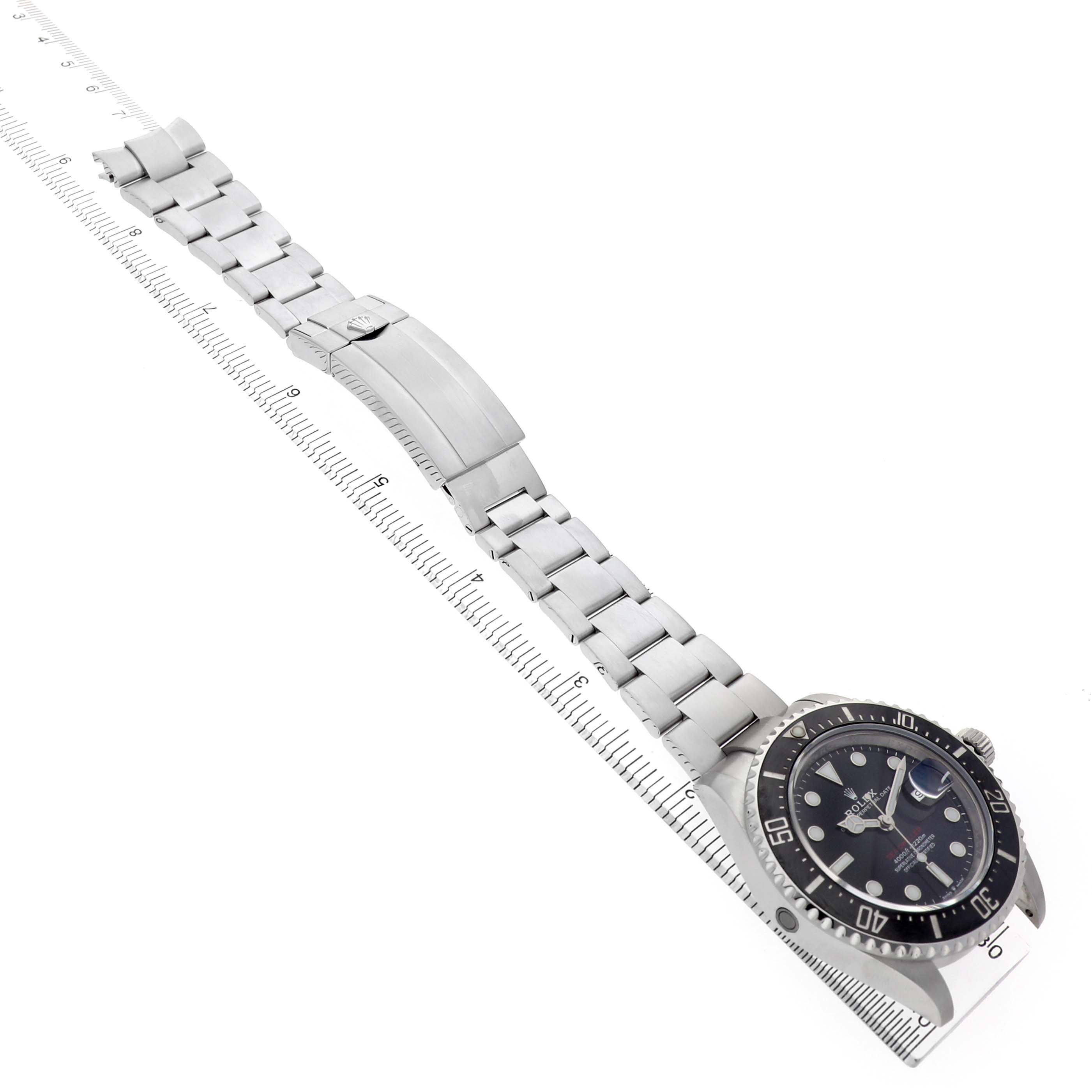 The Rolex Sea-Dweller 126600 Men's Stainless Steel Black Dial watch is shown from a side angle with a focus on the bracelet and clasp.