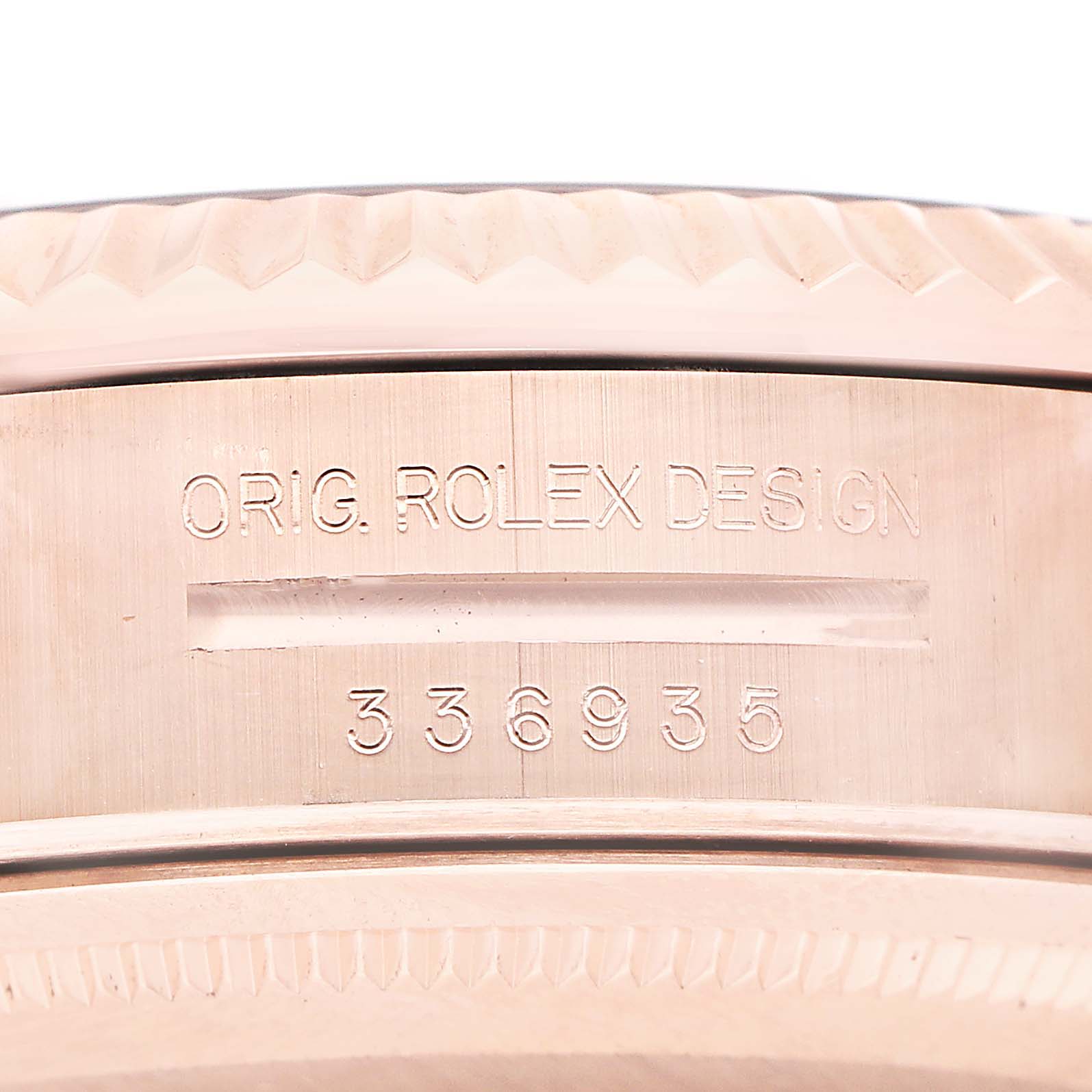 The image shows the side engraving of the Rolex Sky-Dweller 336935 Men's Rose Gold Grey Dial's case with "ORIG. ROLEX DESIGN" and a number.