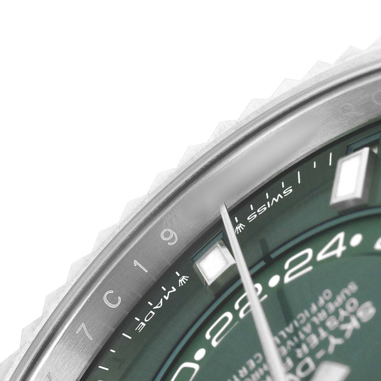 The image shows a close-up of the Rolex Sky-Dweller 336934 Men's Stainless Steel Green Dial's bezel, dial edge, indices, and part of the hand.