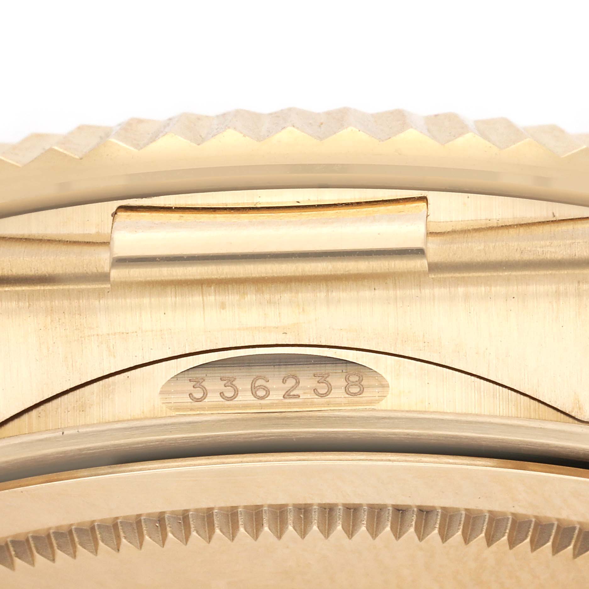 The image shows a close-up of the serial number area and bezel edge of a Rolex Sky-Dweller 336238 Men
s Yellow Gold Silver Dial 336238 Men
s Yellow Gold Silver Dial watch.
