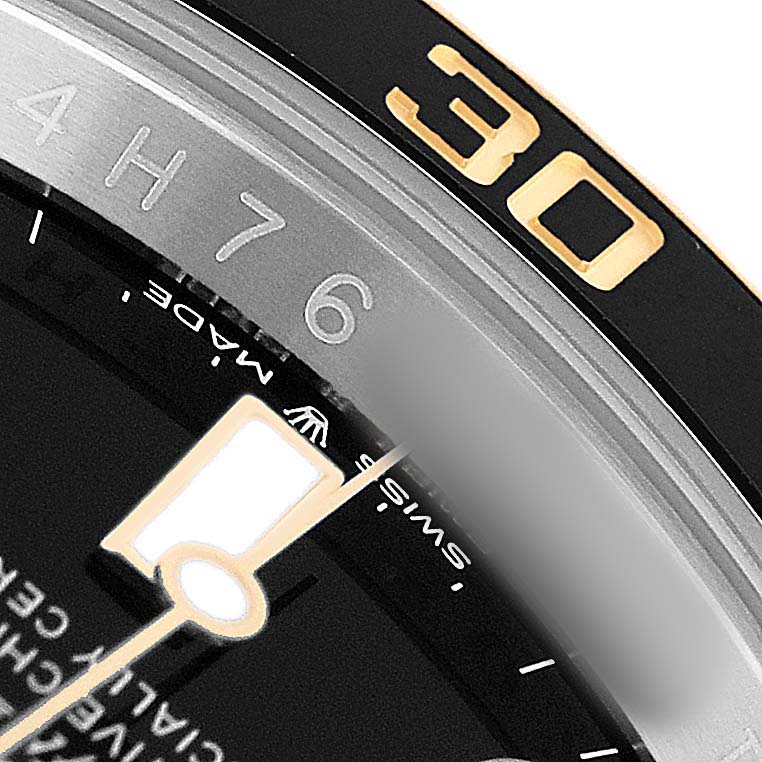 The image shows a close-up of the bezel and part of the dial of a Rolex Submariner 126613 Men's Steel and Gold (two tone) Black Dial watch, focusing on the 30-minute marker.
