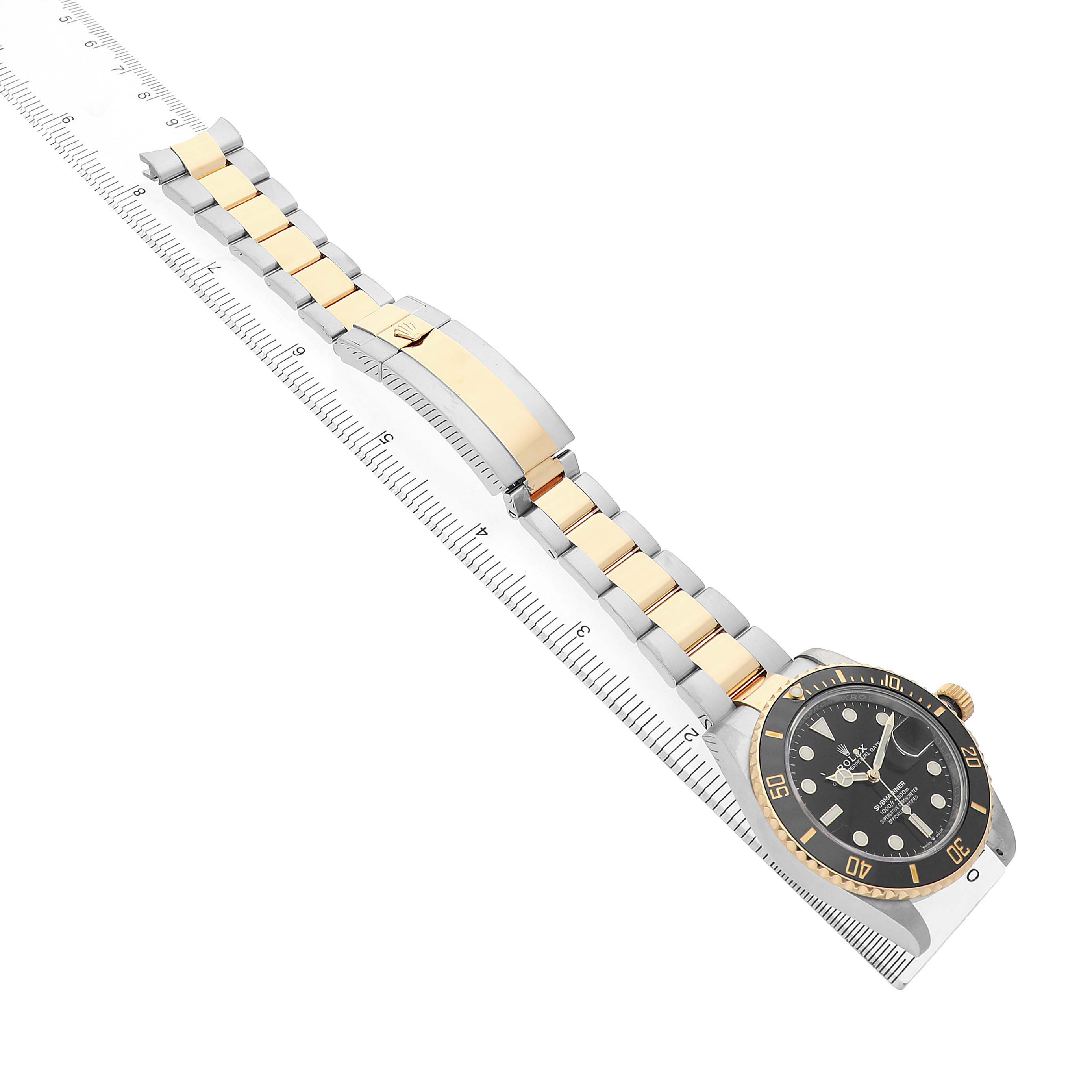 The Rolex Submariner 126613 Men's Steel and Gold (two tone) Black Dial is shown from a top angle, featuring its gold and stainless steel bracelet and black bezel.