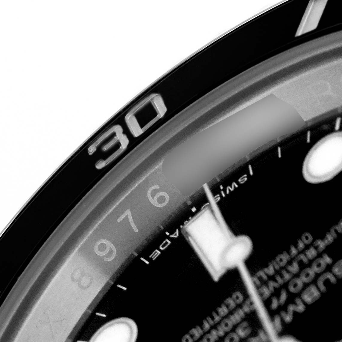The image shows a close-up of the Rolex Submariner 114060 Men's Stainless Steel Black Dial's bezel and dial, highlighting the "30" marker and part of the minute hand.