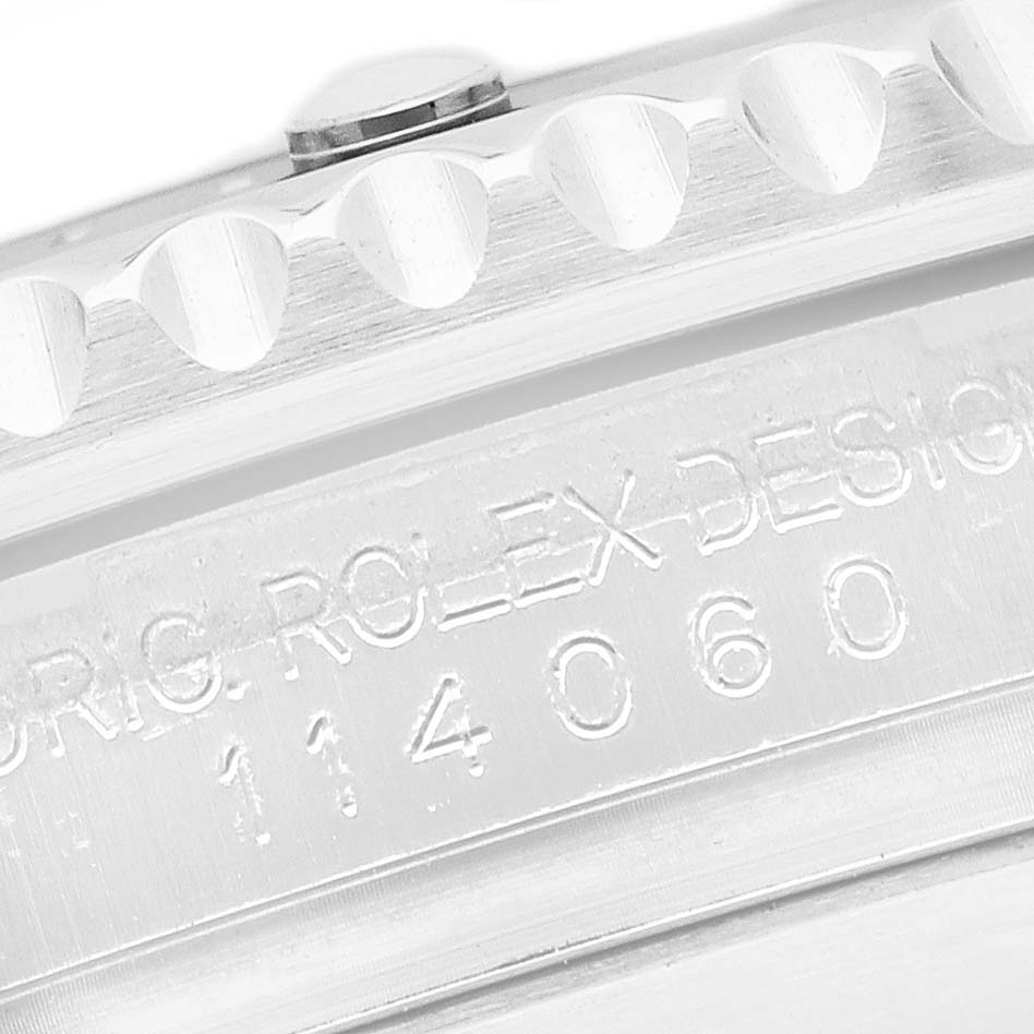The image shows the side view of a Rolex Submariner 114060 Men's Stainless Steel Black Dial's case with the "Orig. Rolex Design" and model number engraved.