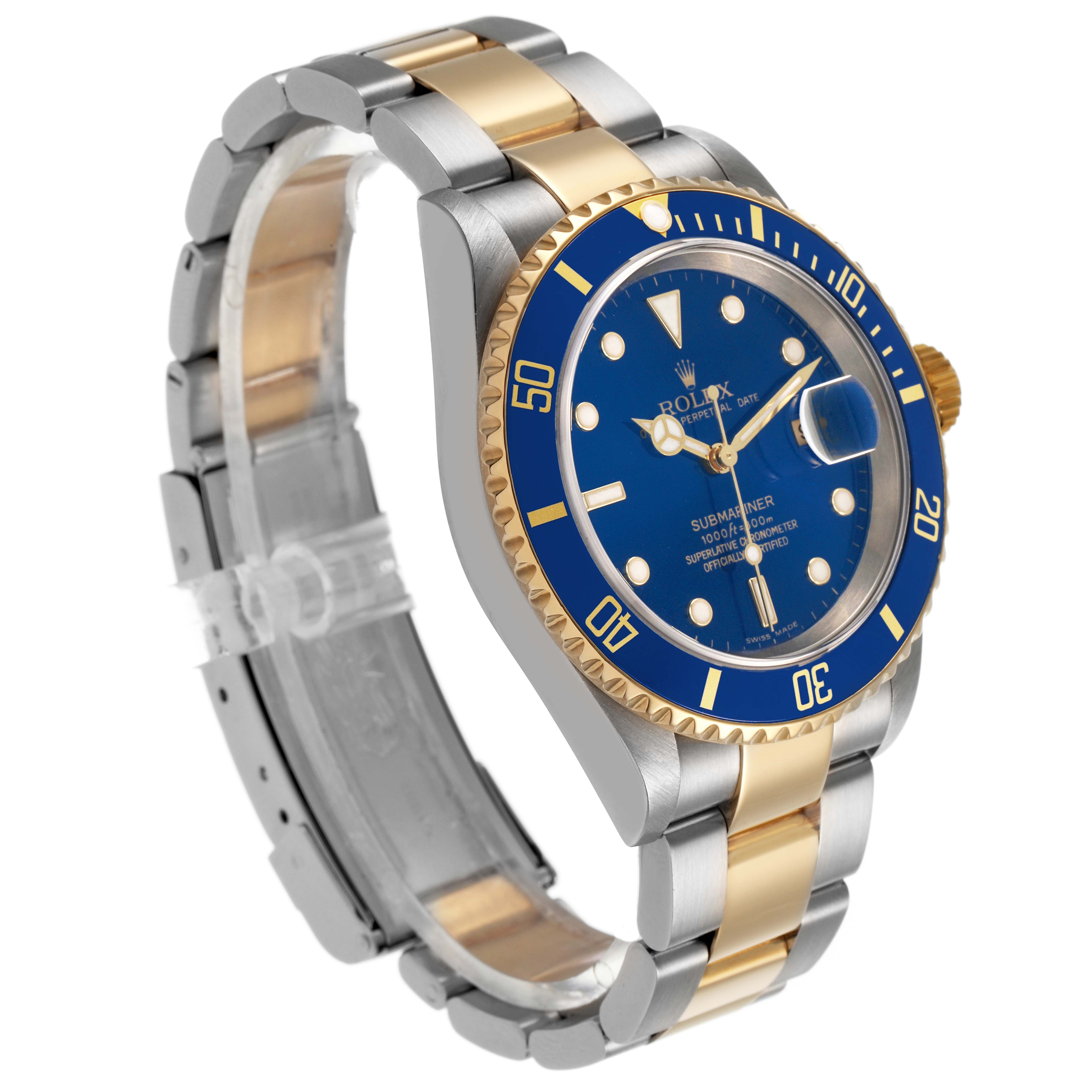 The Rolex Submariner 16613 Men's Steel and Gold (two tone) Blue Dial watch is shown at a three-quarter angle, highlighting the blue dial, gold bezel, and two-tone metal bracelet.