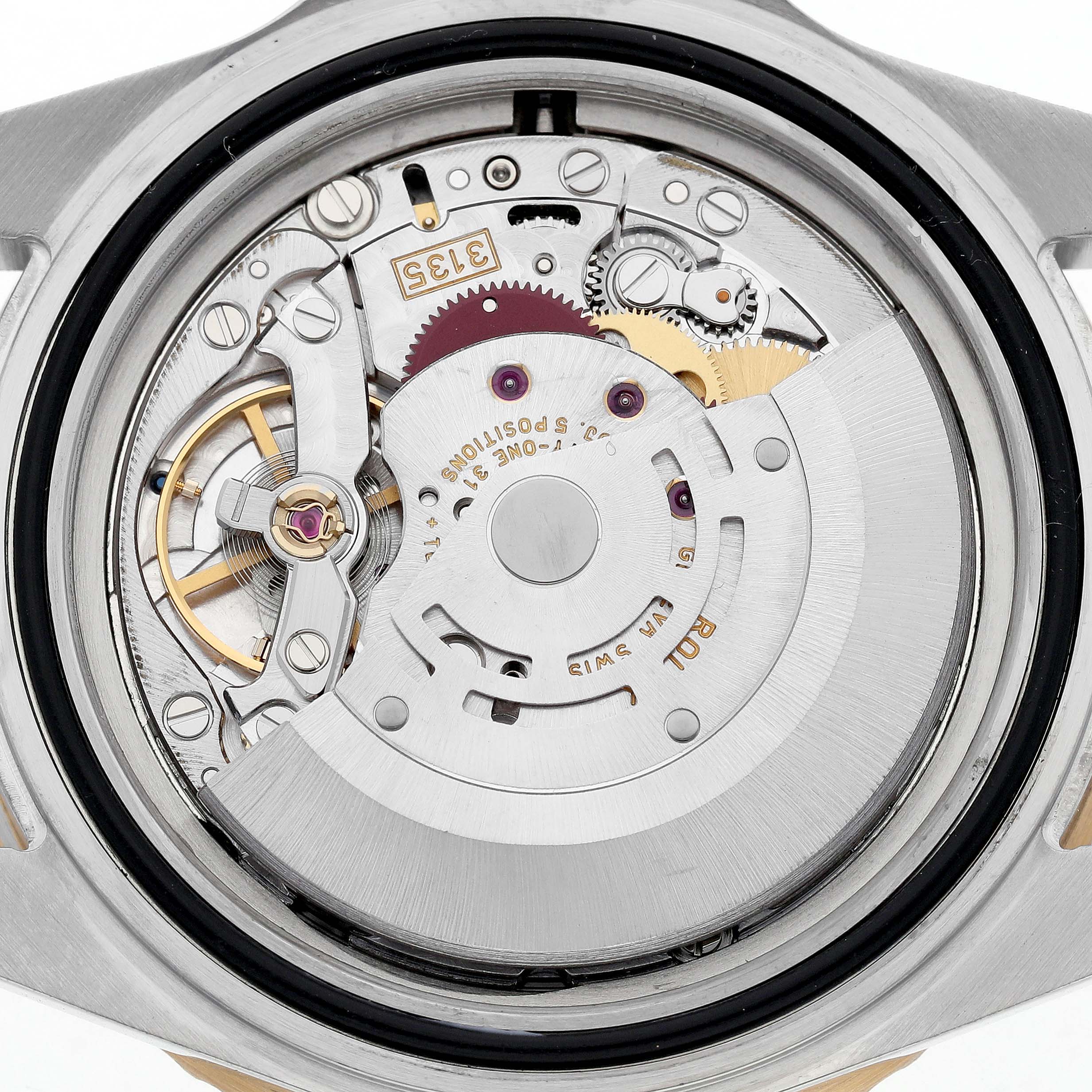The image shows the intricate movement of a Rolex Submariner 16613 Men's Steel and Gold (two tone) Blue Dial watch from a rear angle, highlighting its internal mechanics.