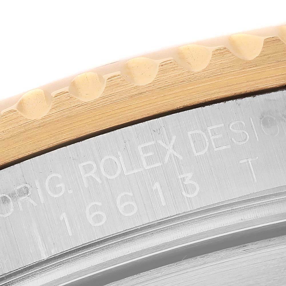 The image shows a close-up of the bezel edge and case side of a Rolex Submariner 16613 Men's Steel and Gold (two tone) Blue Dial, highlighting the engraving.