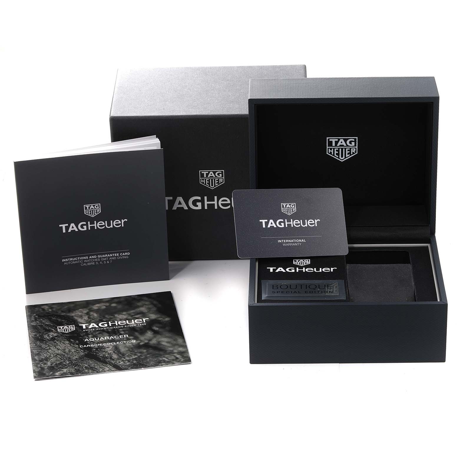 This image shows the packaging, booklet, warranty card, and storage box for the Tag Heuer Aquaracer watch.