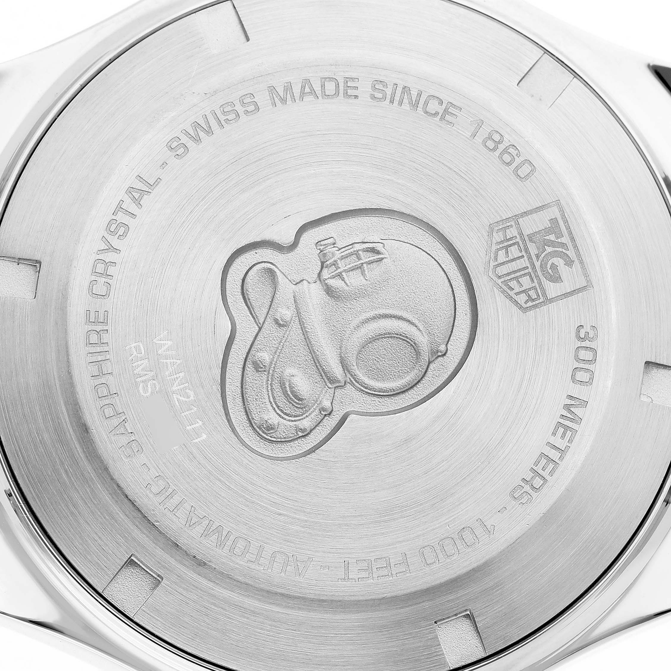 The image shows the case back of a Tag Heuer Aquaracer WAN2111 Men's Stainless Steel Blue Dial watch with engravings and a diver helmet motif.