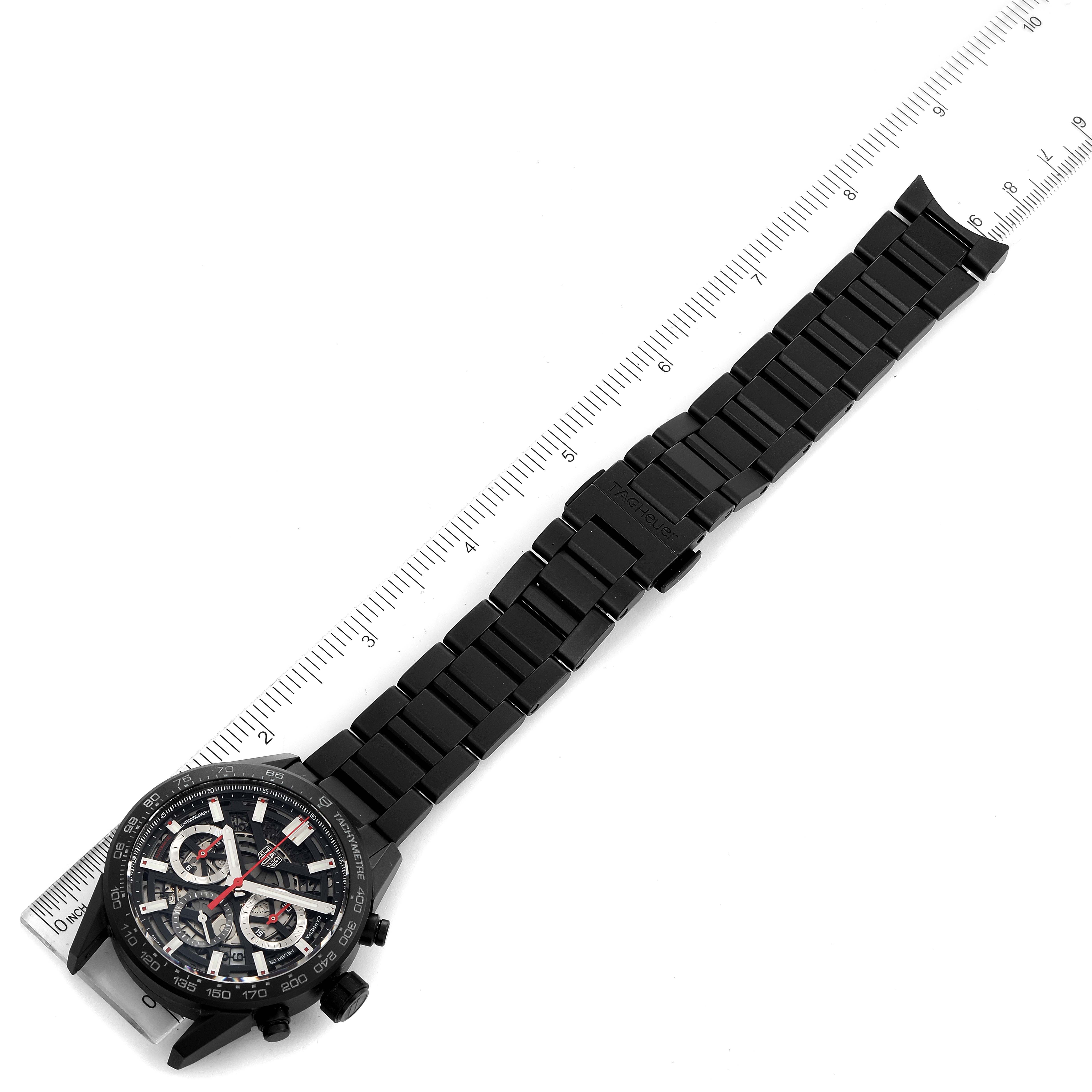 The image displays a Tag Heuer Carrera CBG2090.BH0661 Men's Titanium Black Dial CBG2090.BH0661 Men's Titanium Black Dial watch laid flat with its strap fully extended next to a ruler for scale.