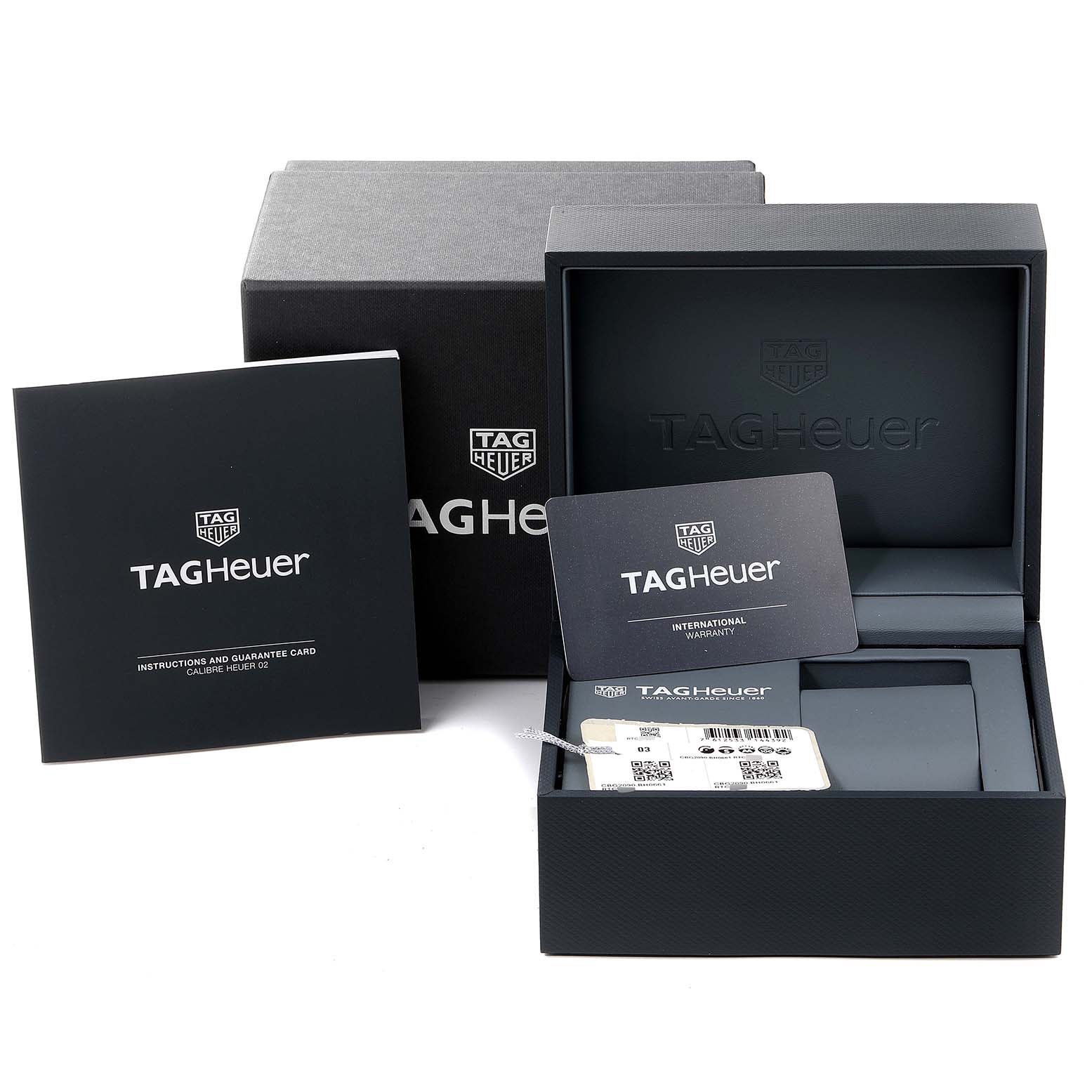 The image shows the packaging and accessories for a Tag Heuer Carrera CBG2090.BH0661 Men's Titanium Black Dial CBG2090.BH0661 Men's Titanium Black Dial watch, including the box, warranty card, and instruction manual.