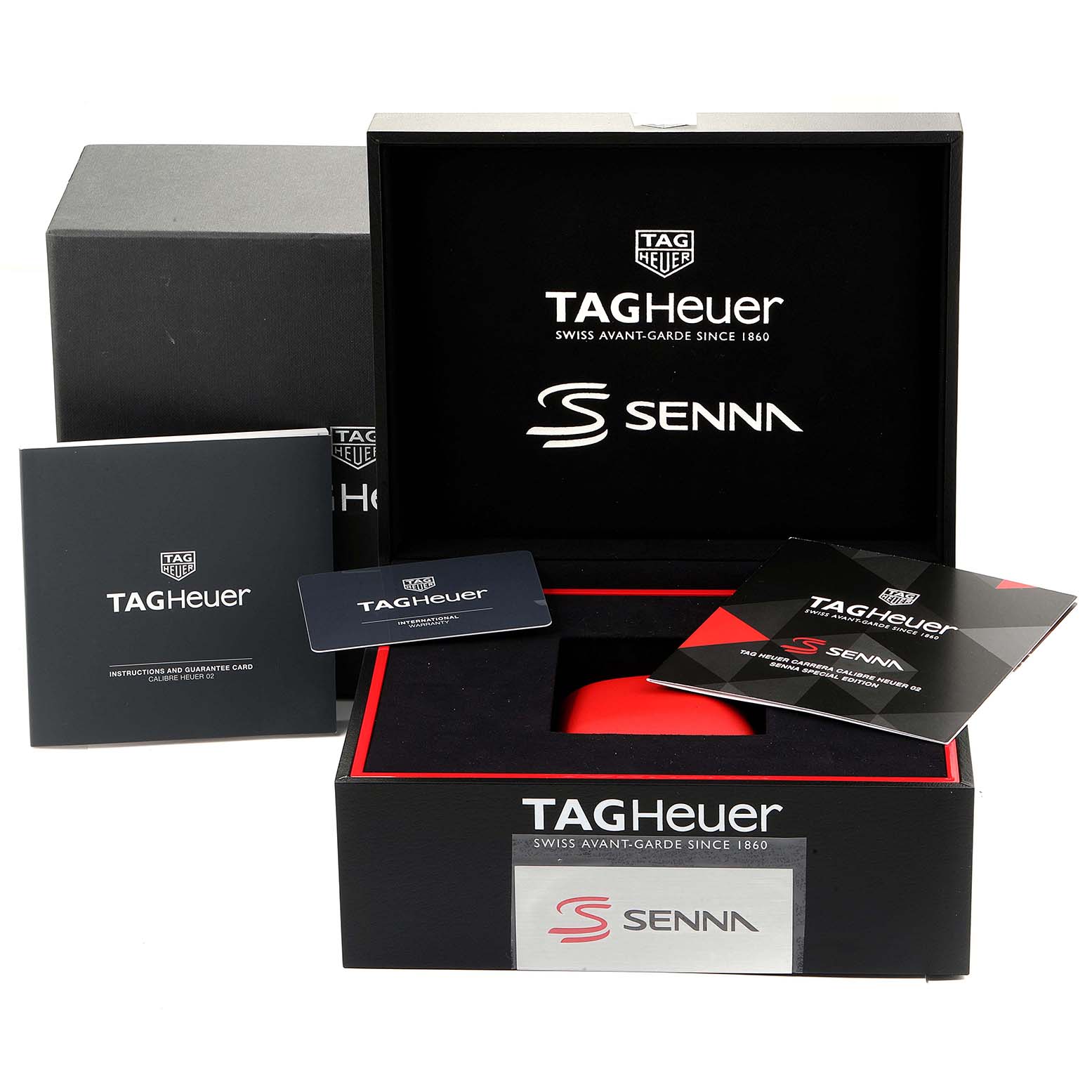 The image shows the packaging and accessories for the Tag Heuer Carrera CBG2013.BA0657 Men's Stainless Steel Transparent Dial CBG2013.BA0657 Men's Stainless Steel Transparent Dial Senna watch, including the box, manual, and guarantee card.