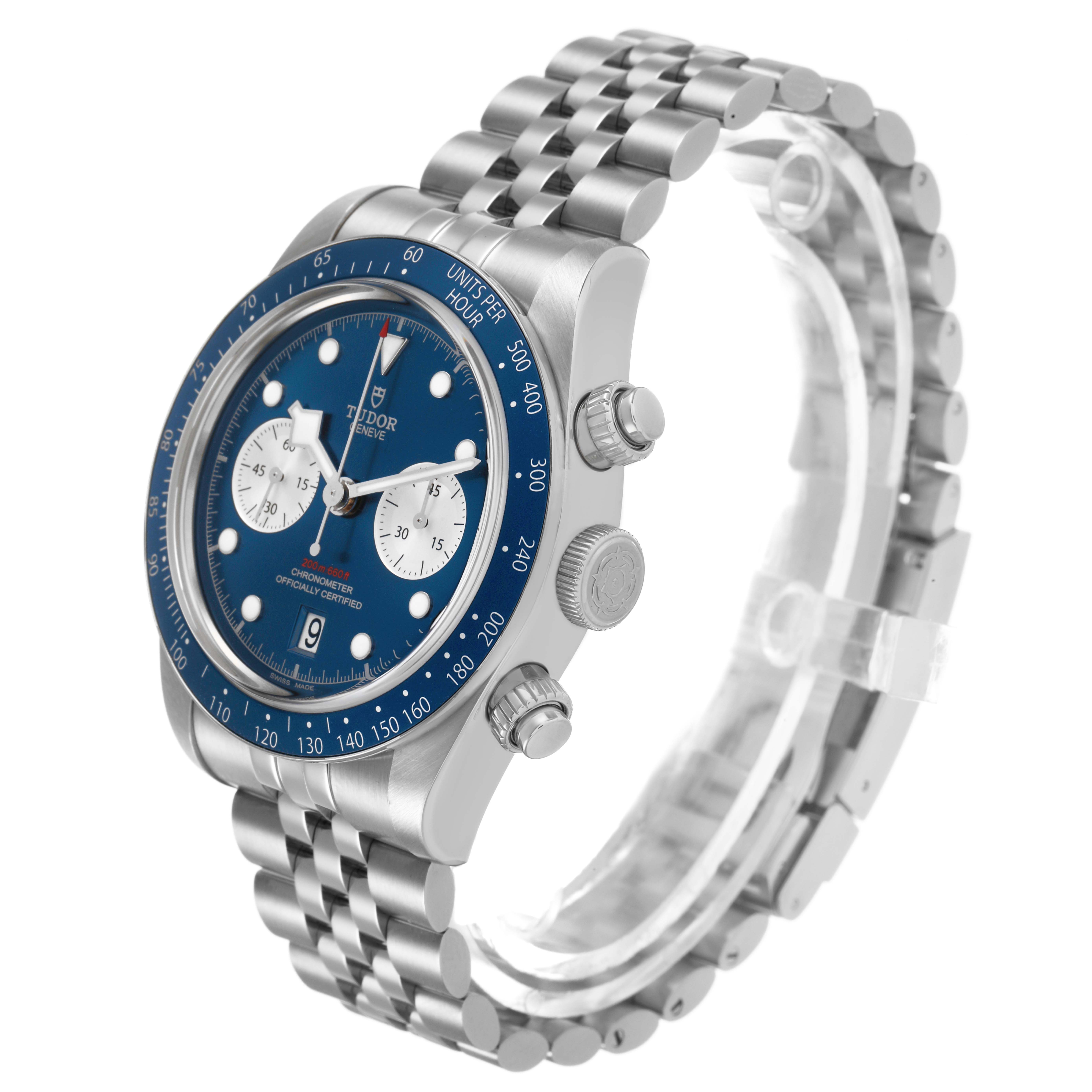 The Tudor Heritage Chrono 79360B Men's Stainless Steel Blue Dial watch is shown at an angled side view, displaying its bezel, crown, pushers, and bracelet.