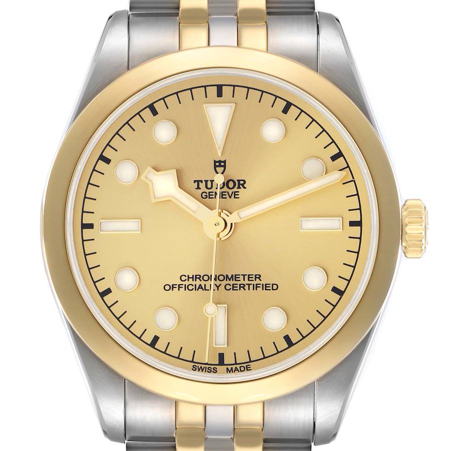 The Tudor Heritage Black Bay watch is shown from a front view, highlighting its gold dial, hands, indices, bezel, and two-tone bracelet.