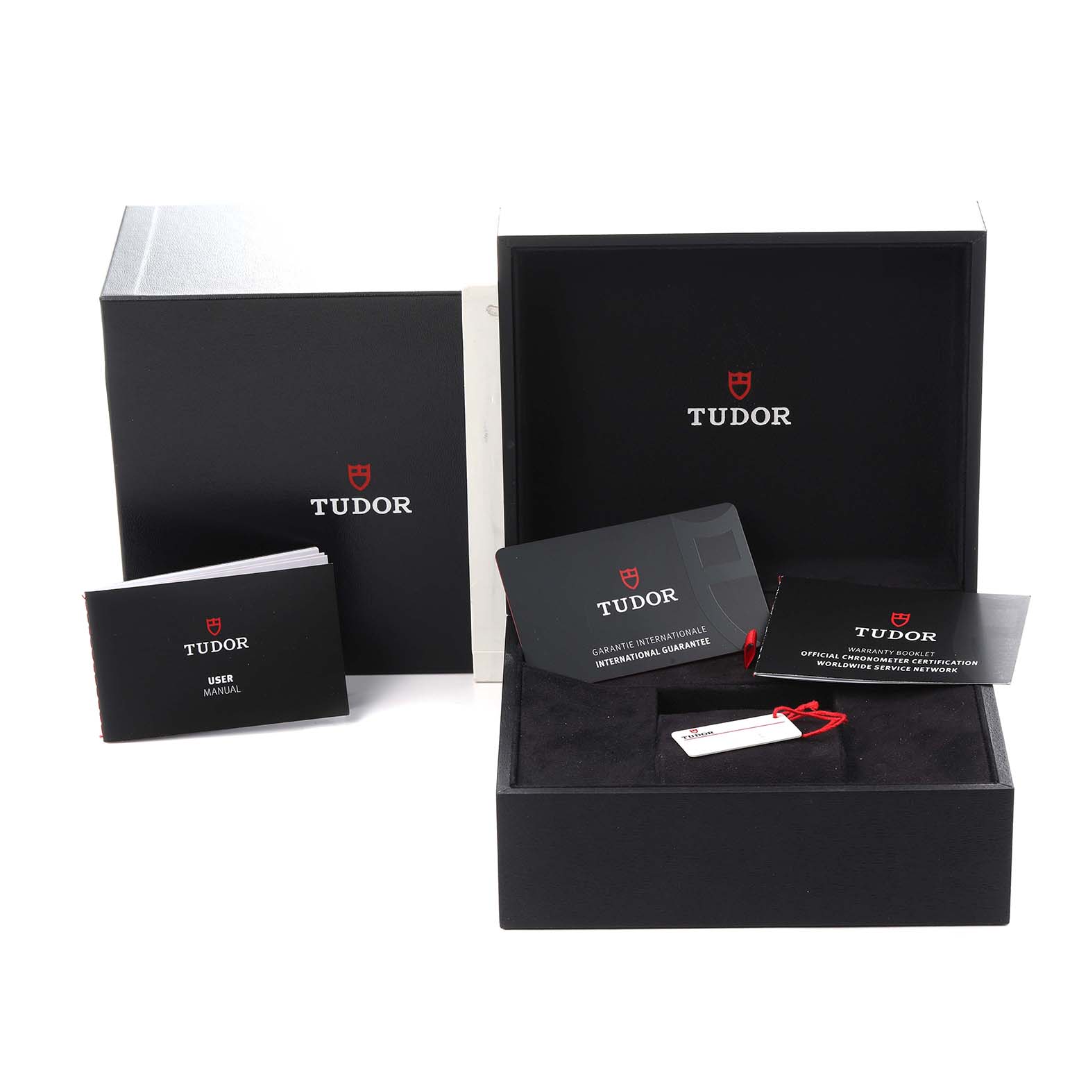 The image shows the packaging and accessories for a Tudor Heritage Black Bay M79643-0005 Men
s Steel and Gold (two tone) Champagne Dial M79643-0005 Men
s Steel and Gold (two tone) Champagne Dial, including boxes, manuals, and warranty cards.