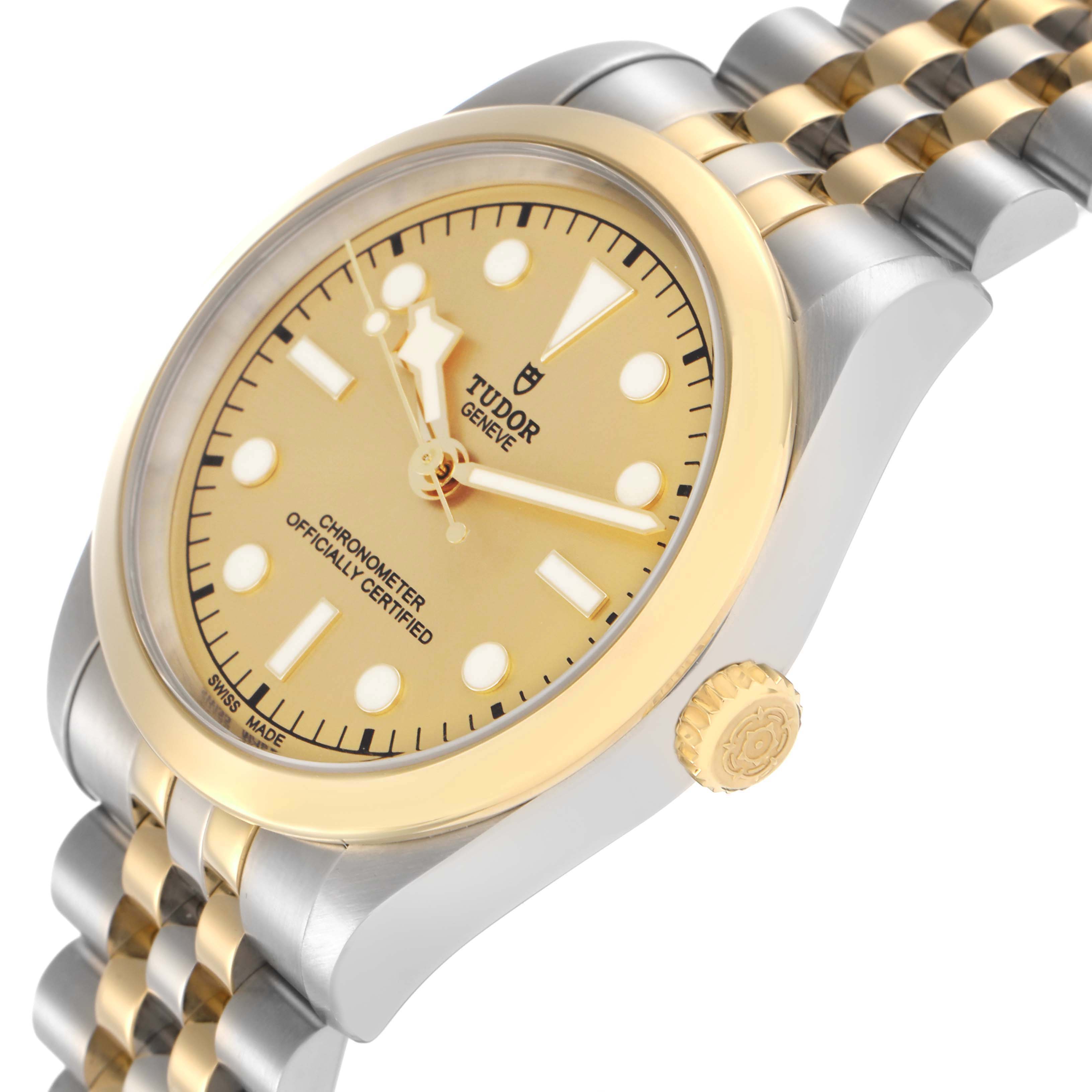 The Tudor Heritage Black Bay M79643-0005 Men
s Steel and Gold (two tone) Champagne Dial watch is angled to show the face, bezel, crown, and part of the bracelet.