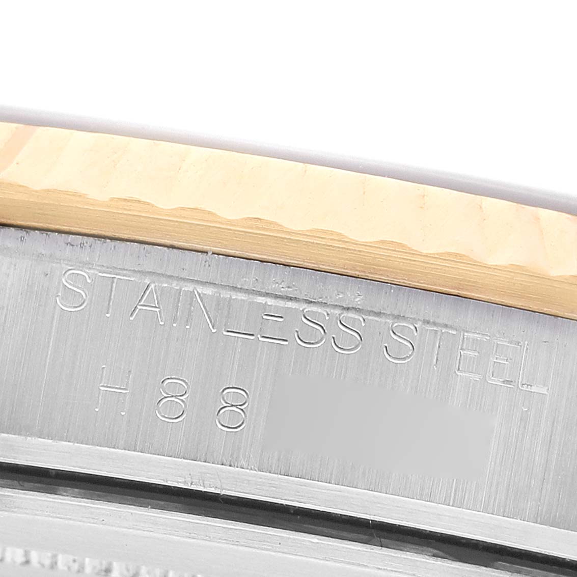The image shows a close-up of the Tudor Prince 76213 Men's Stainless Steel Champagne Dial model's stainless steel watch edge with etched markings.