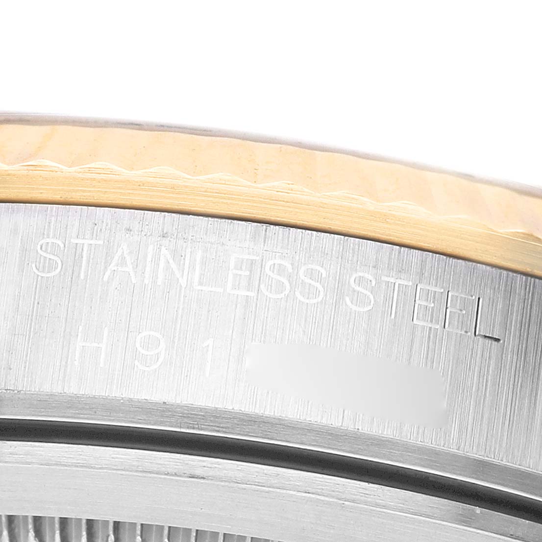 The image shows a close-up of the stainless steel case back edge of a Tudor Prince 76213 Men's Stainless Steel Champagne Dial watch.