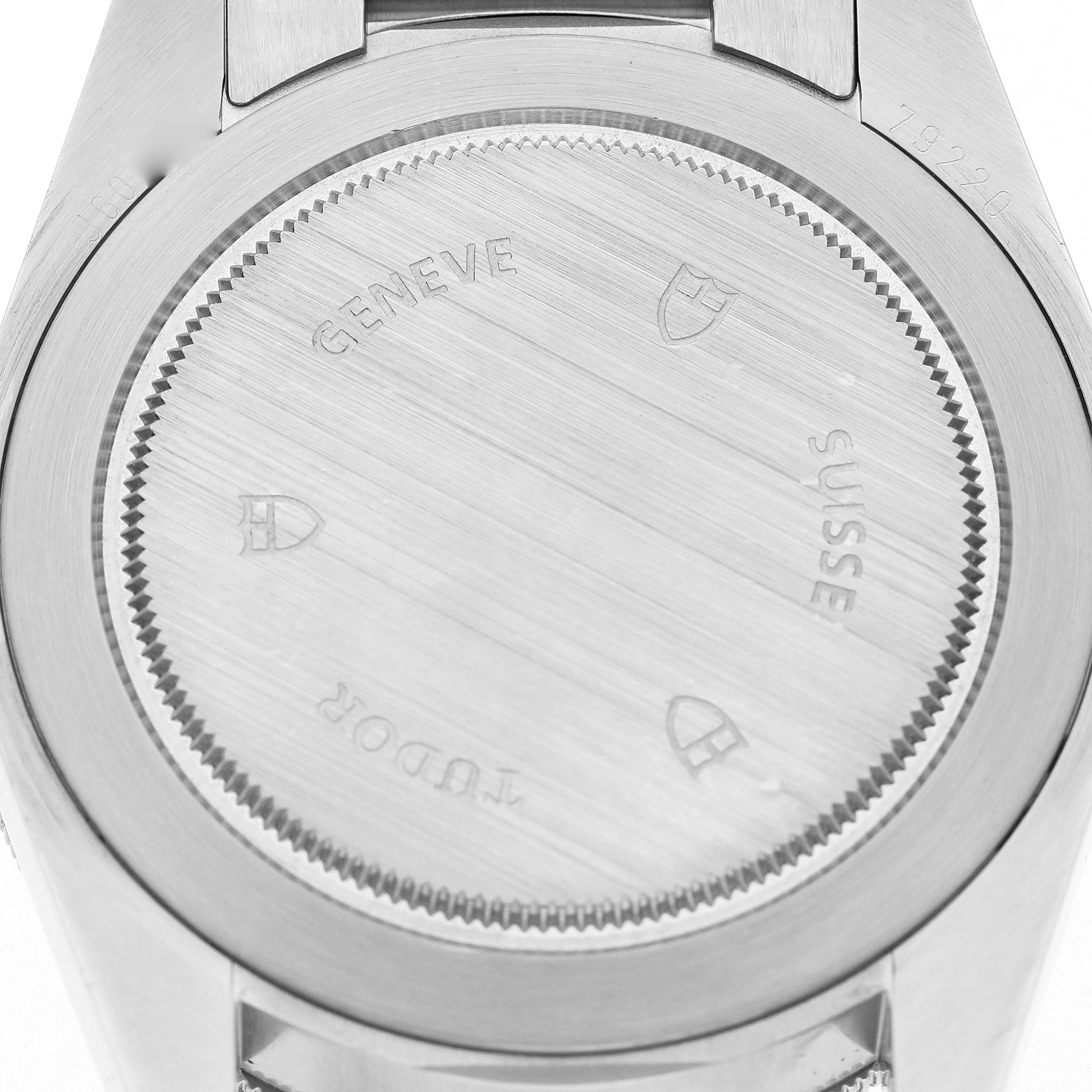The image shows the back of a Tudor Heritage Black Bay 79220R Men's Stainless Steel Black Dial watch, highlighting the case back and engravings.