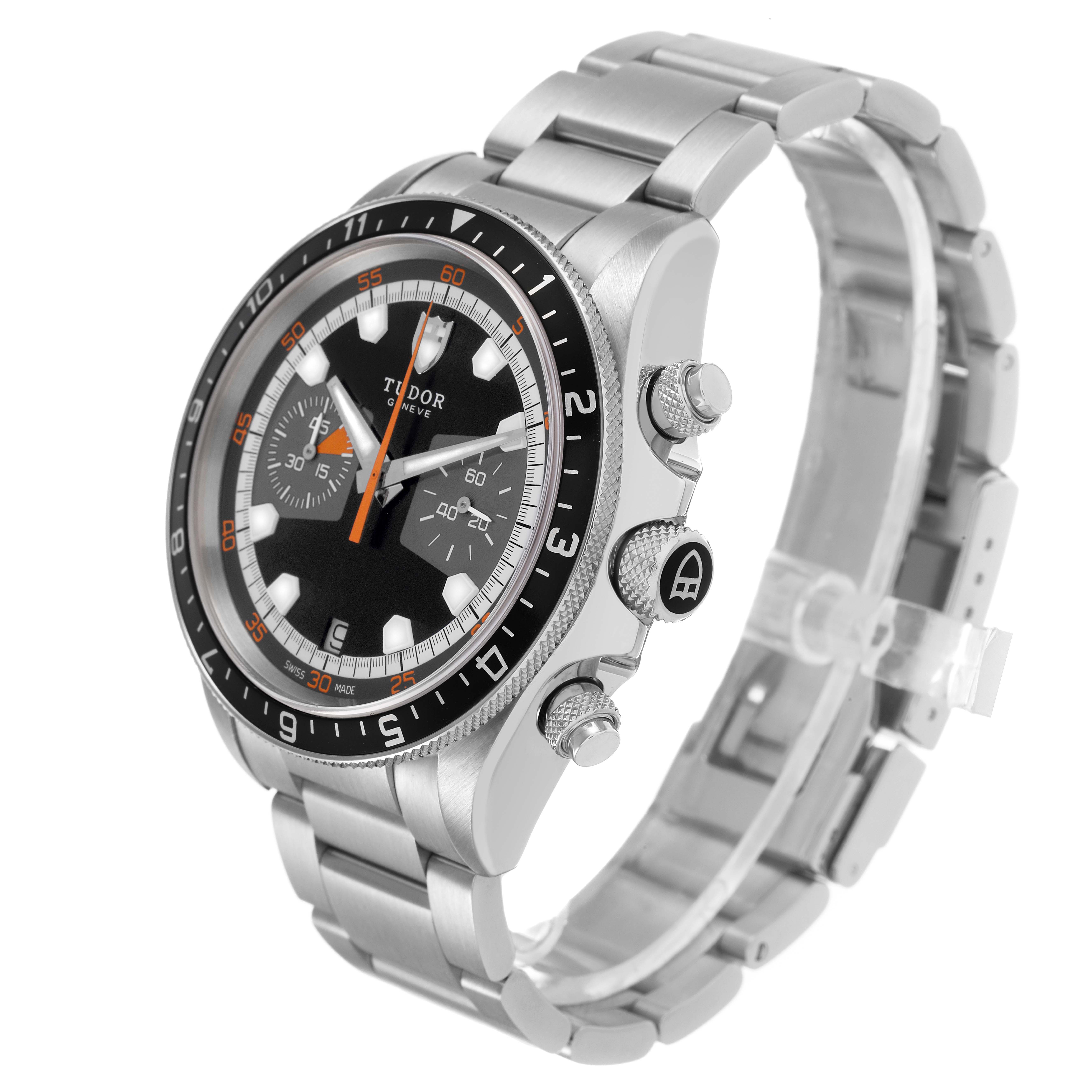 The Tudor Heritage Chrono 70330N Men's Stainless Steel Black Dial watch is shown at a three-quarter angle, displaying the face, bezel, crown, pushers, and bracelet.