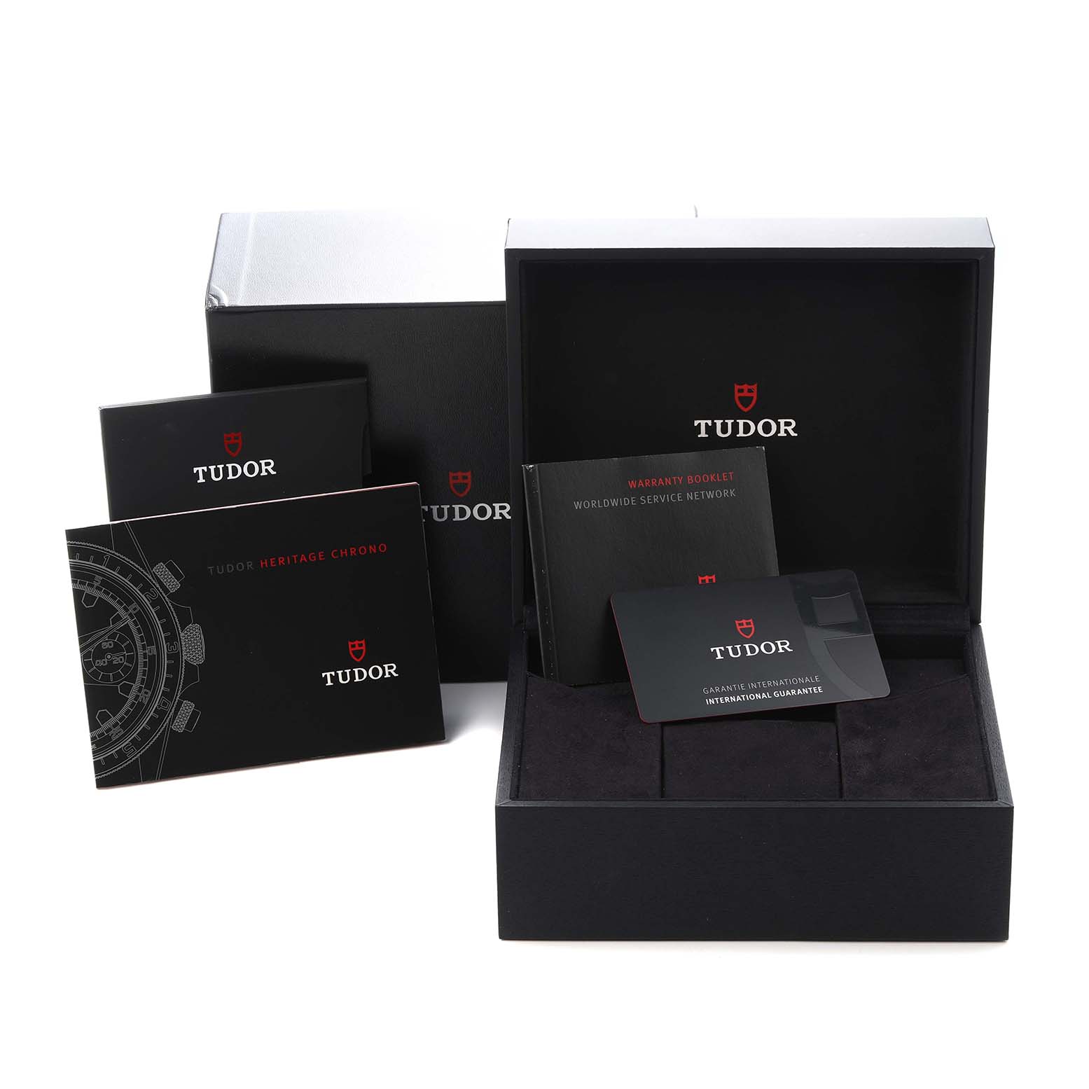 The image shows Tudor Heritage Chrono 70330N-65740 Men
s Stainless Steel Grey Dial 70330N-65740 Men
s Stainless Steel Grey Dial packaging with manuals and a guarantee card, but the watch itself isn
t displayed.