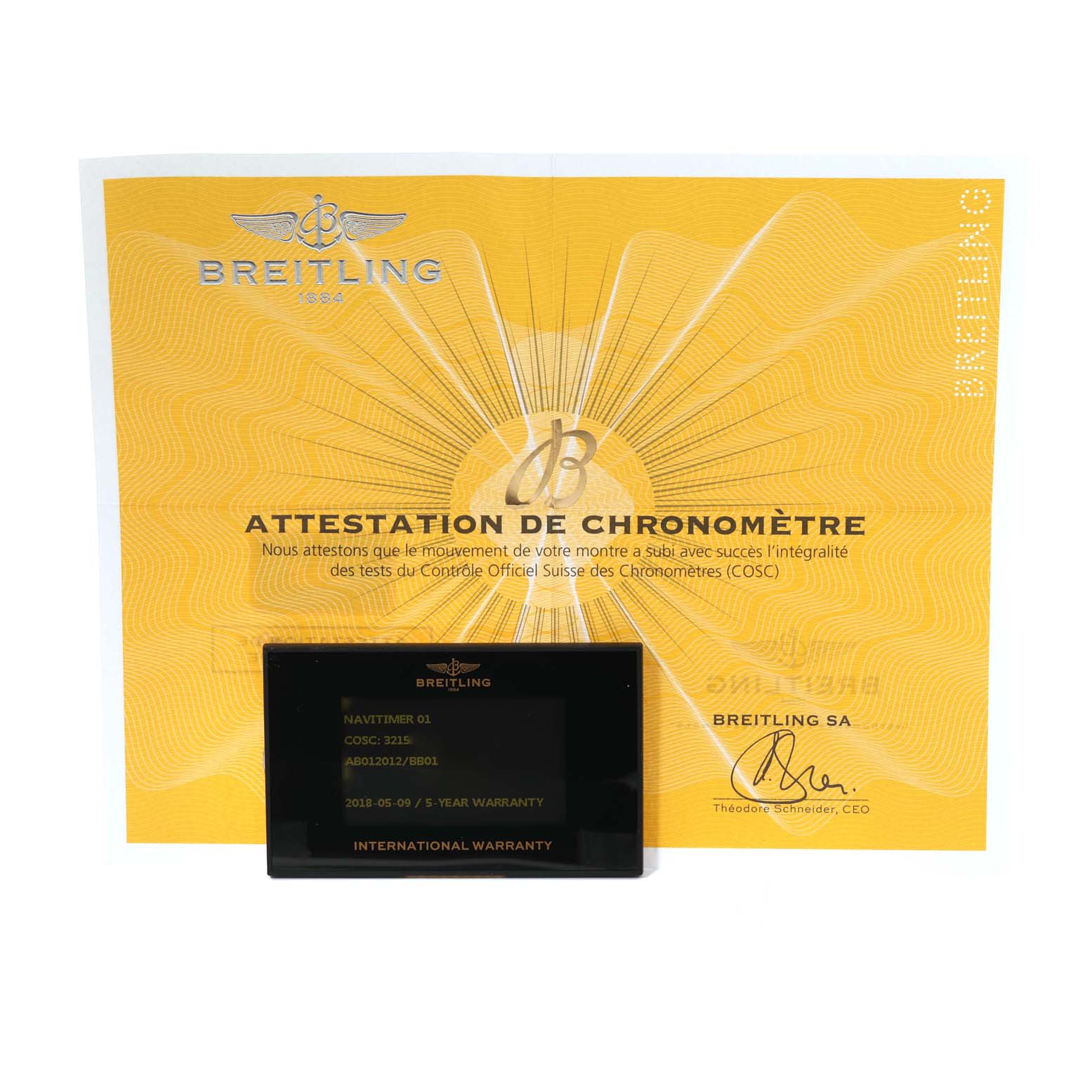 The image shows the Breitling Navitimer AB0120 Men
s Stainless Steel Black Dial AB0120 Men
s Stainless Steel Black Dial model
s chronometer certificate and international warranty card.