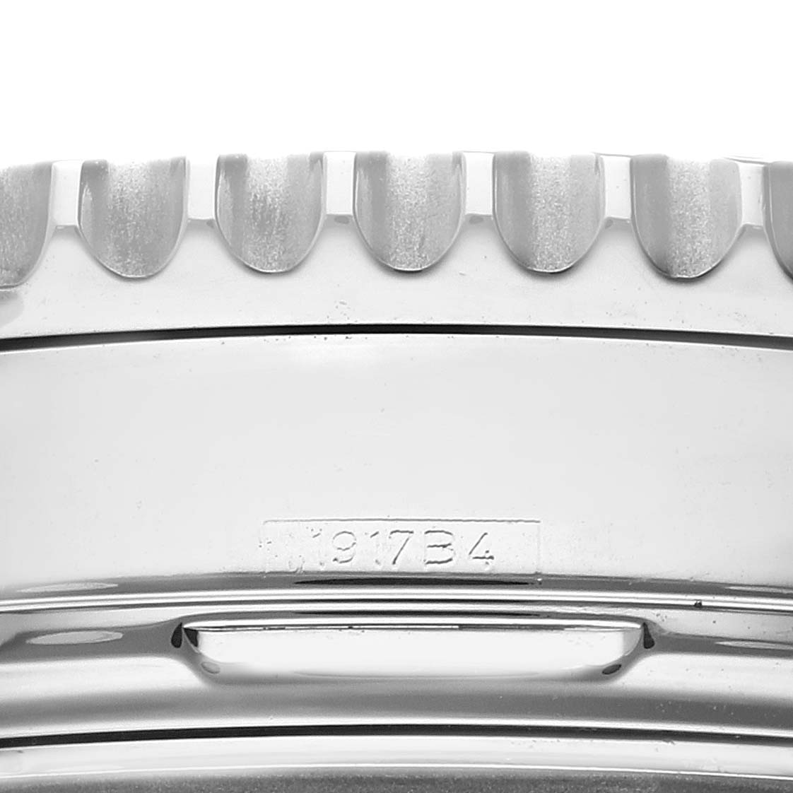 This close-up image of a Breitling Navitimer AB0120 Men
s Stainless Steel Black Dial AB0120 Men
s Stainless Steel Black Dial watch shows the side of the bezel and part of the case with engraved markings.