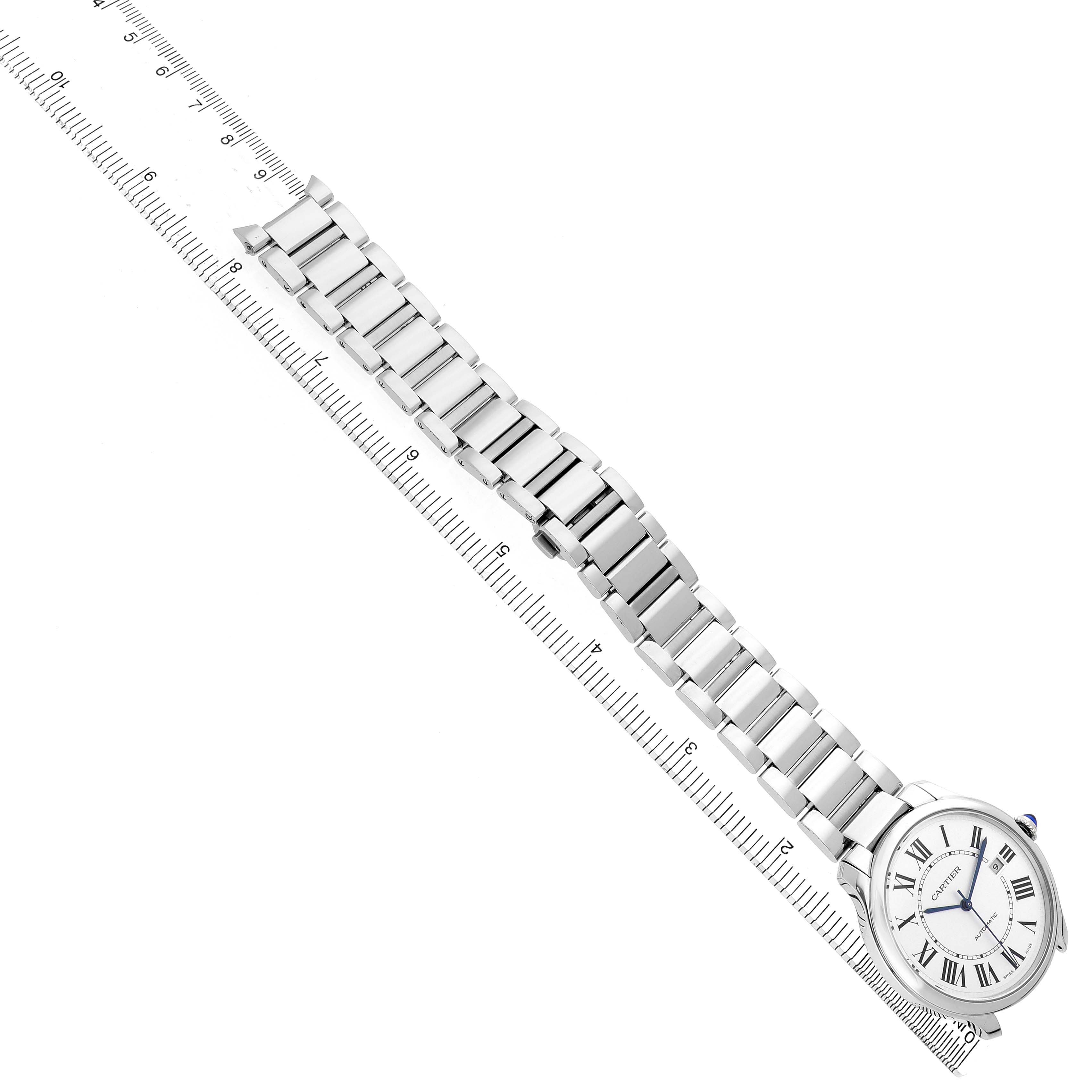 The Cartier Ronde WSRN0035 Men's Stainless Steel Silver Dial watch is shown from a top view, displaying its face, bracelet, and a ruler for scale.