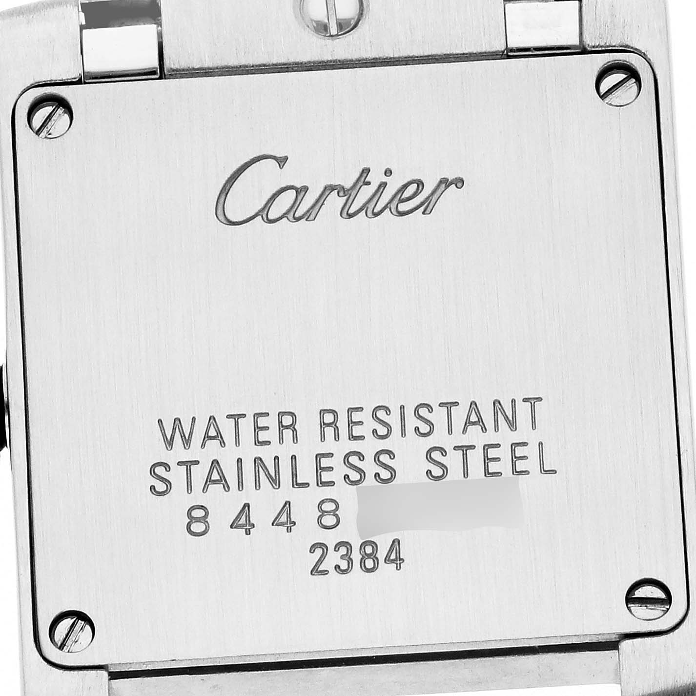 The image shows the back of a Cartier Tank Française model W51007Q4 men's watch, displaying markings for water resistance and stainless steel.