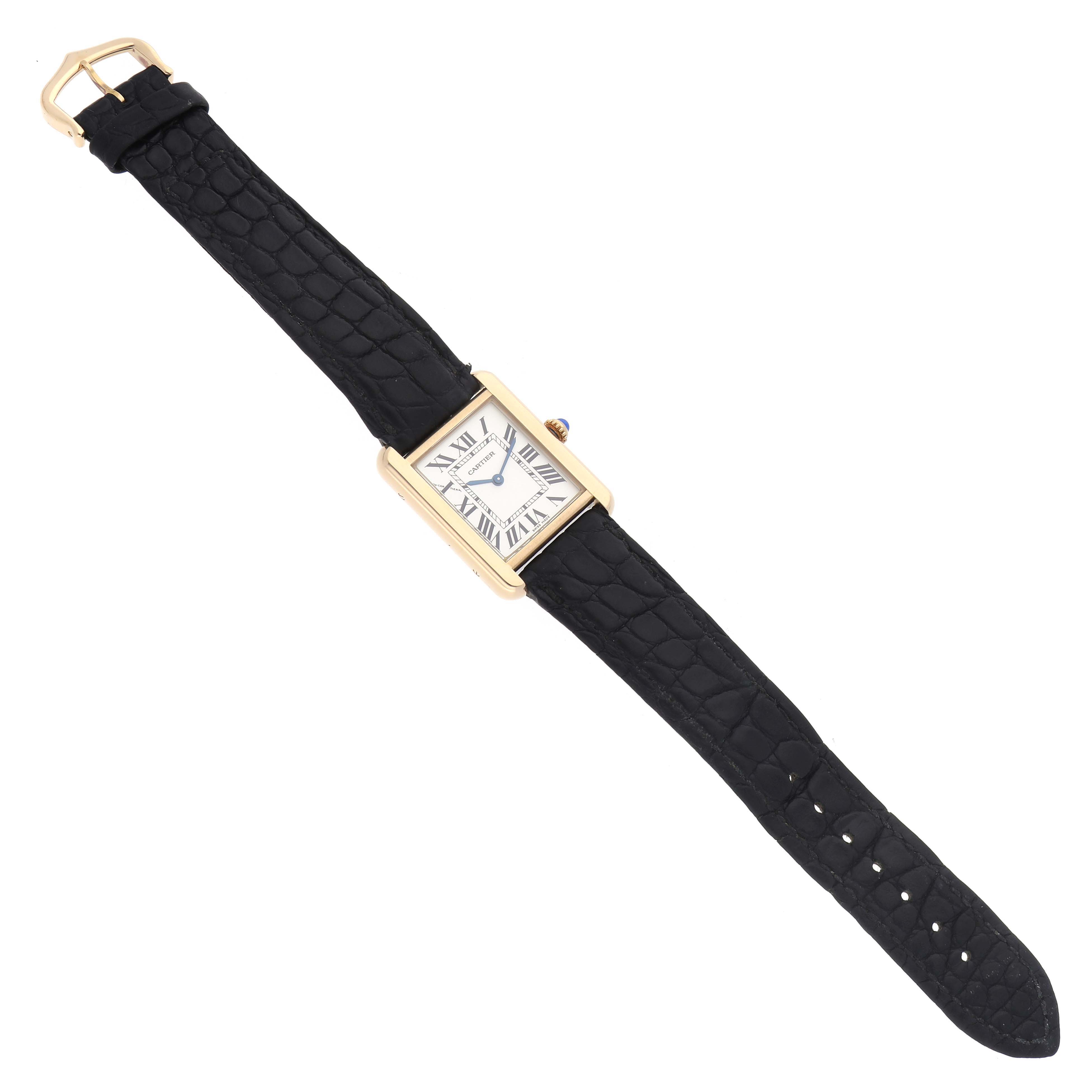 The Cartier Tank Solo model W1018755 men's watch is shown from a top-down angle, displaying the rectangular face, black strap, and gold case.