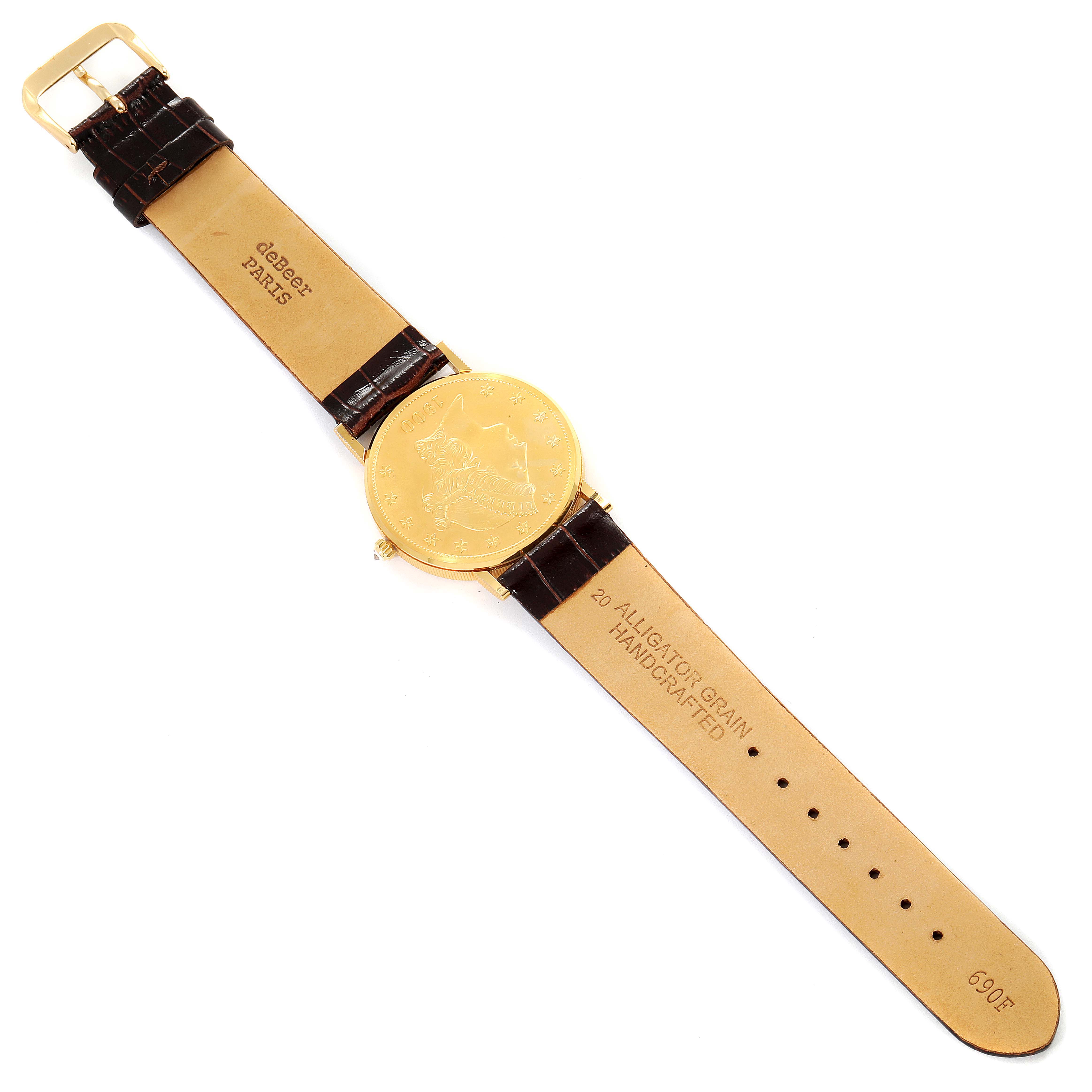 The image shows the Corum Coin Watch 1900 Men's Yellow Gold Black Dial 1900 Men's Yellow Gold Black Dial model laid flat from a top-down angle, displaying its gold face and brown leather strap.