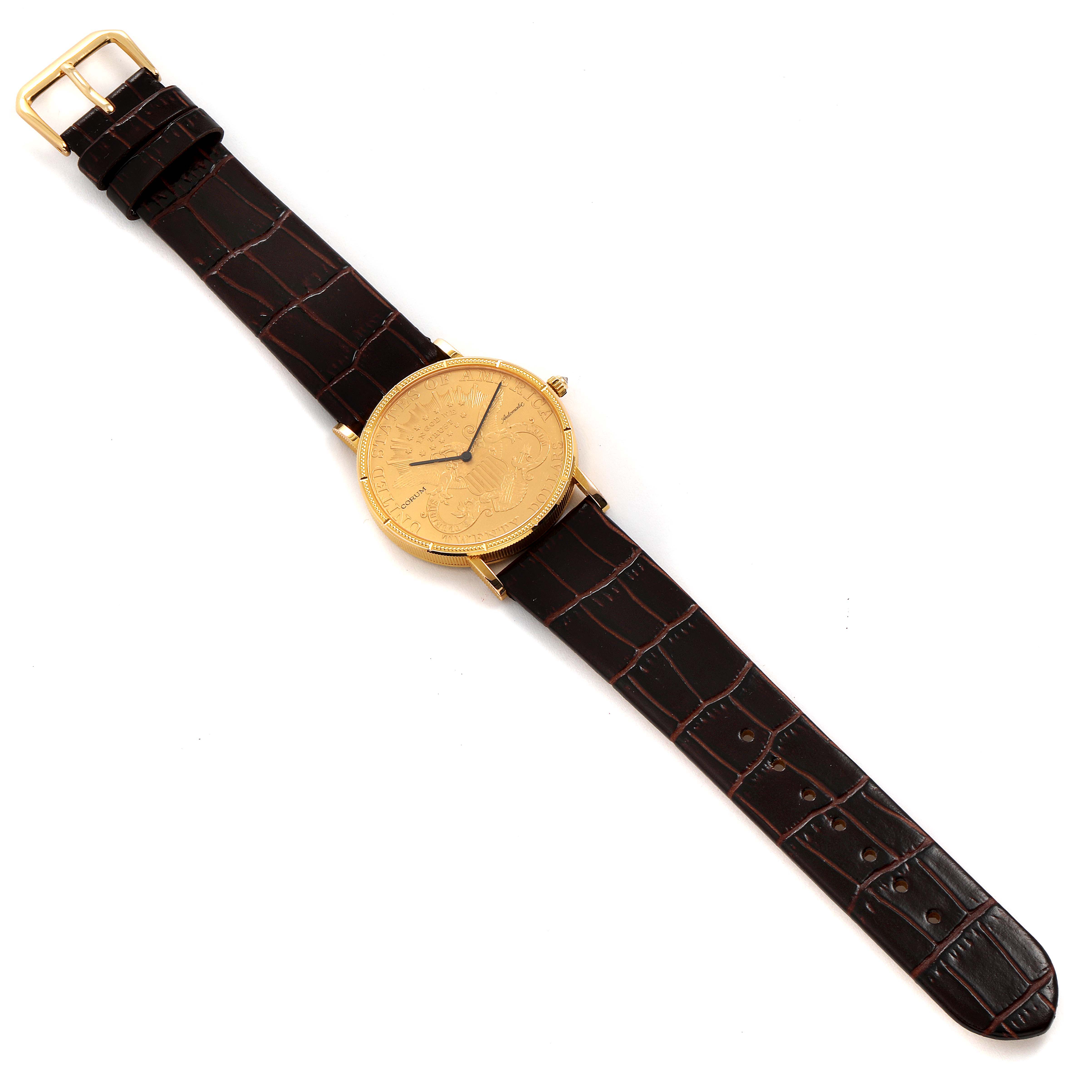 The image shows a top-down view of a Corum Coin Watch 1900 Men's Yellow Gold Black Dial 1900 Men's Yellow Gold Black Dial model with its full face, hour and minute hands, and leather strap visible.