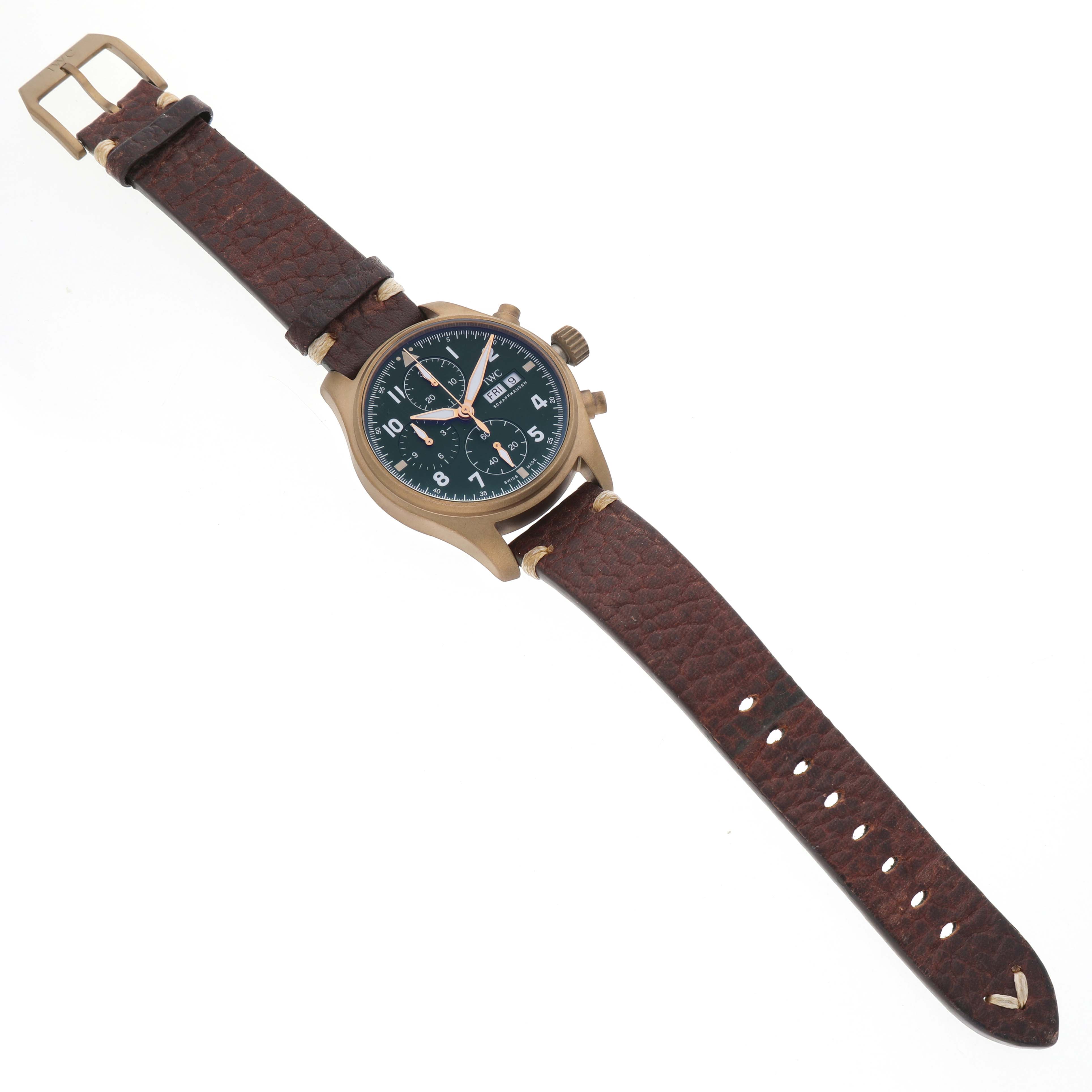 The IWC Pilot IW387902 Men's Bronze Green Dial model watch is displayed flat, showcasing the dial, case, crown, chronograph buttons, and leather strap.