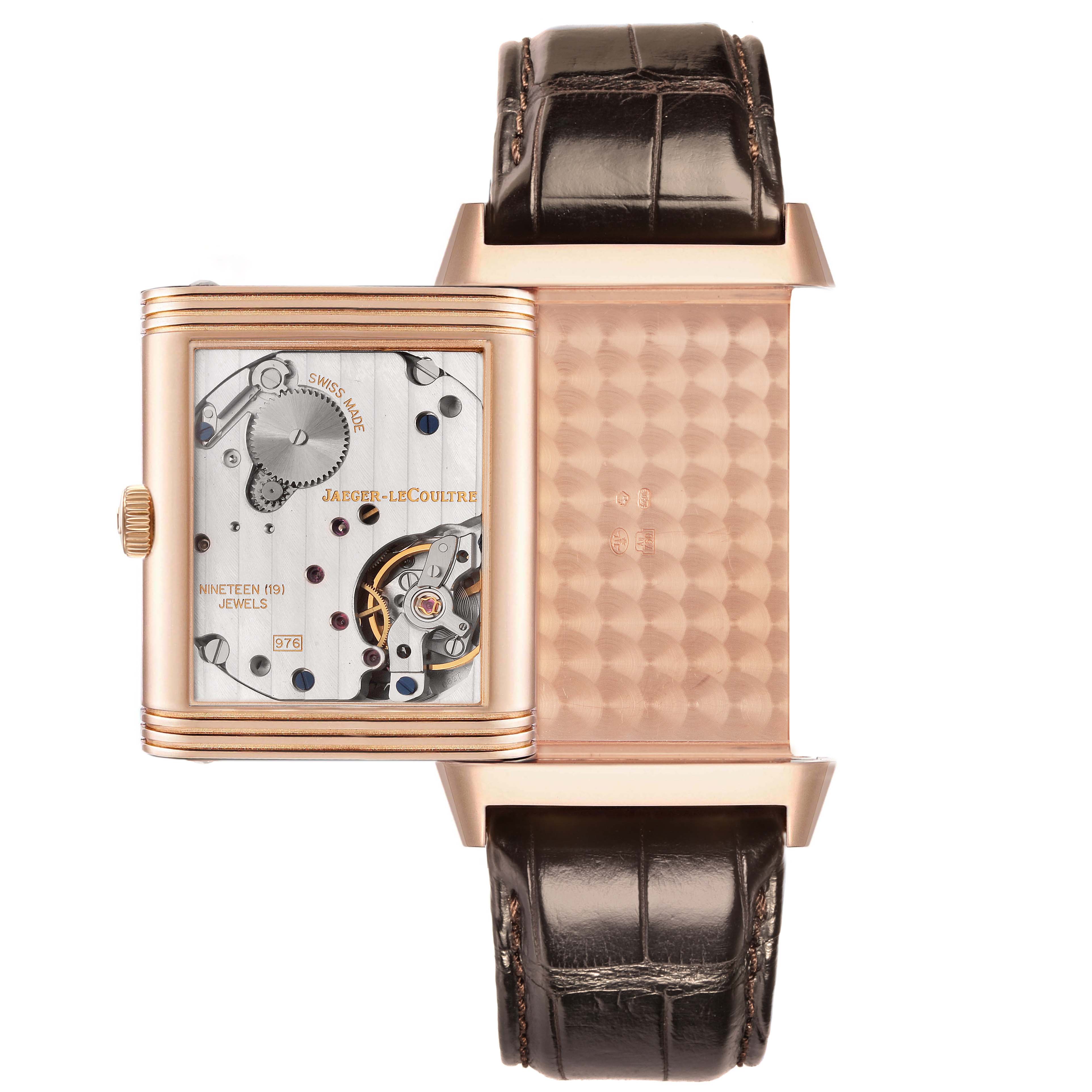The image shows the Jaeger LeCoultre Reverso Q3732420 men
s watch open, revealing its mechanical movement and intricate inner details from a top view.