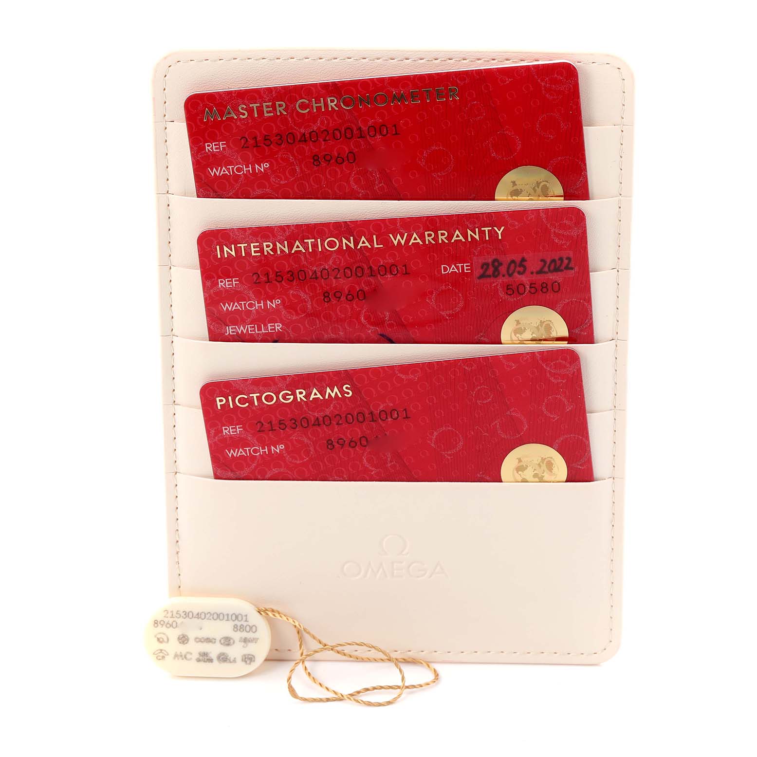 The image shows Omega Planet Ocean model 215.30.40.20.01.001 cards for Master Chronometer, Warranty, and Pictograms in a holder, with a tag attached.