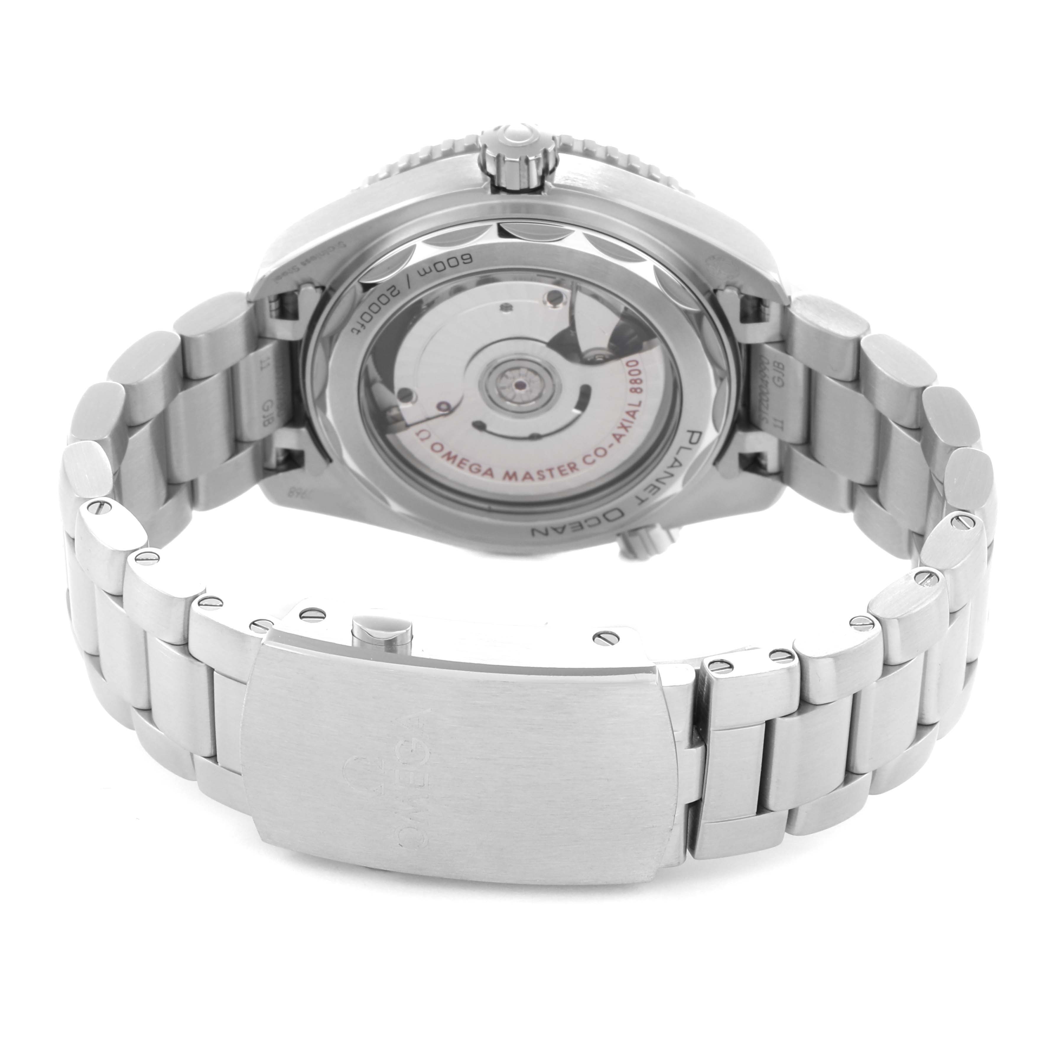 The image shows the back of the Omega Planet Ocean model 215.30.40.20.01.001, highlighting its transparent case back and stainless steel bracelet.