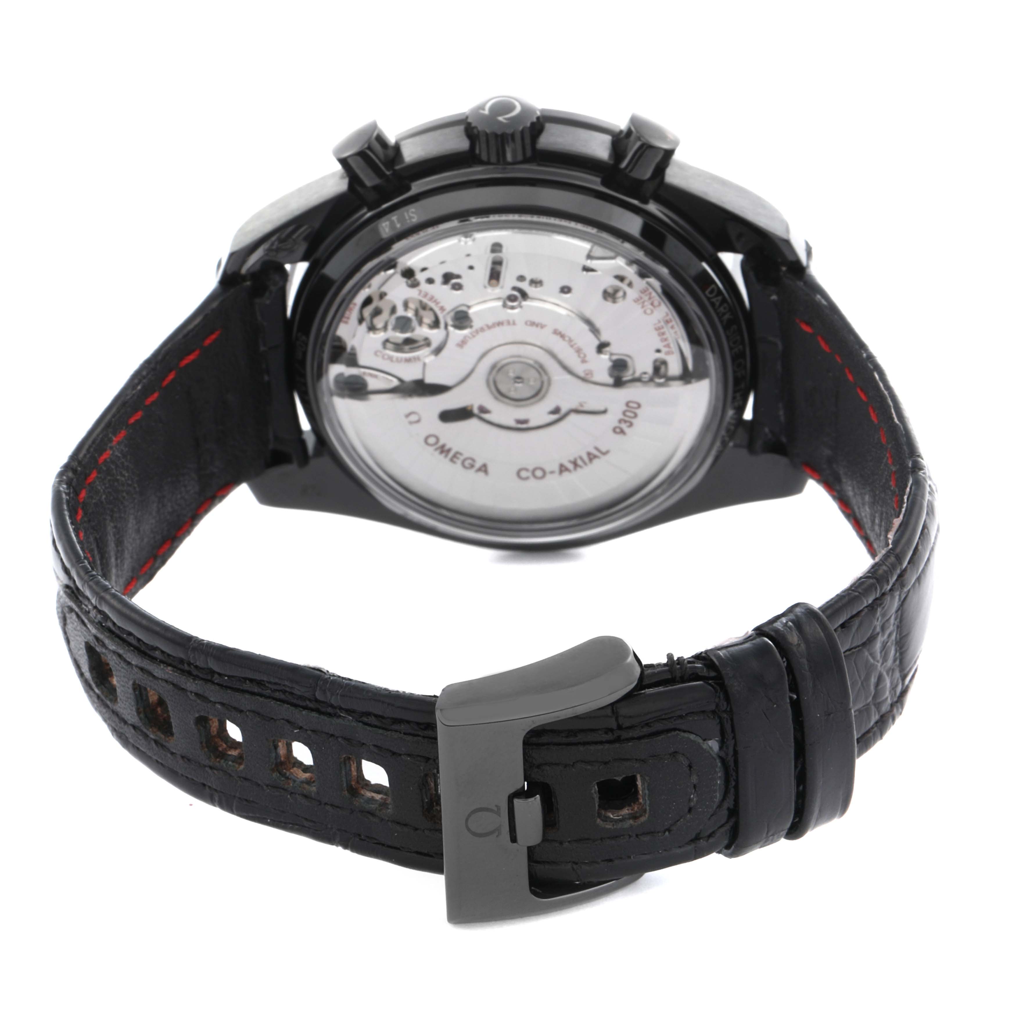 The Omega Speedmaster 311.92.44.51.01.003 Men's Ceramic Black Dial watch is shown from the back, highlighting the transparent case back and leather strap with clasp.