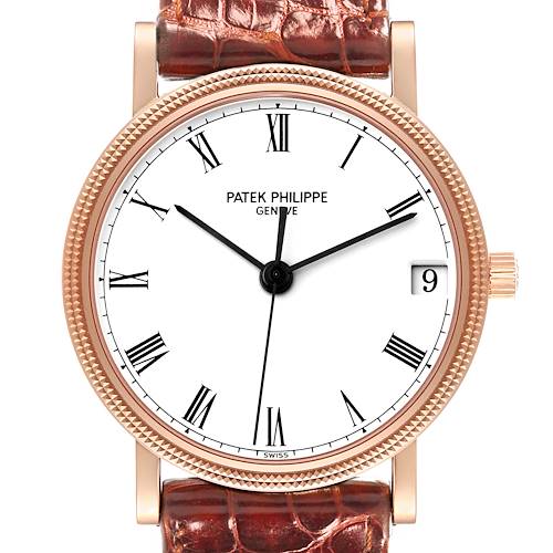 The image shows a close-up of the face of a Patek Philippe Calatrava watch, highlighting its Roman numerals, date window, and leather strap.