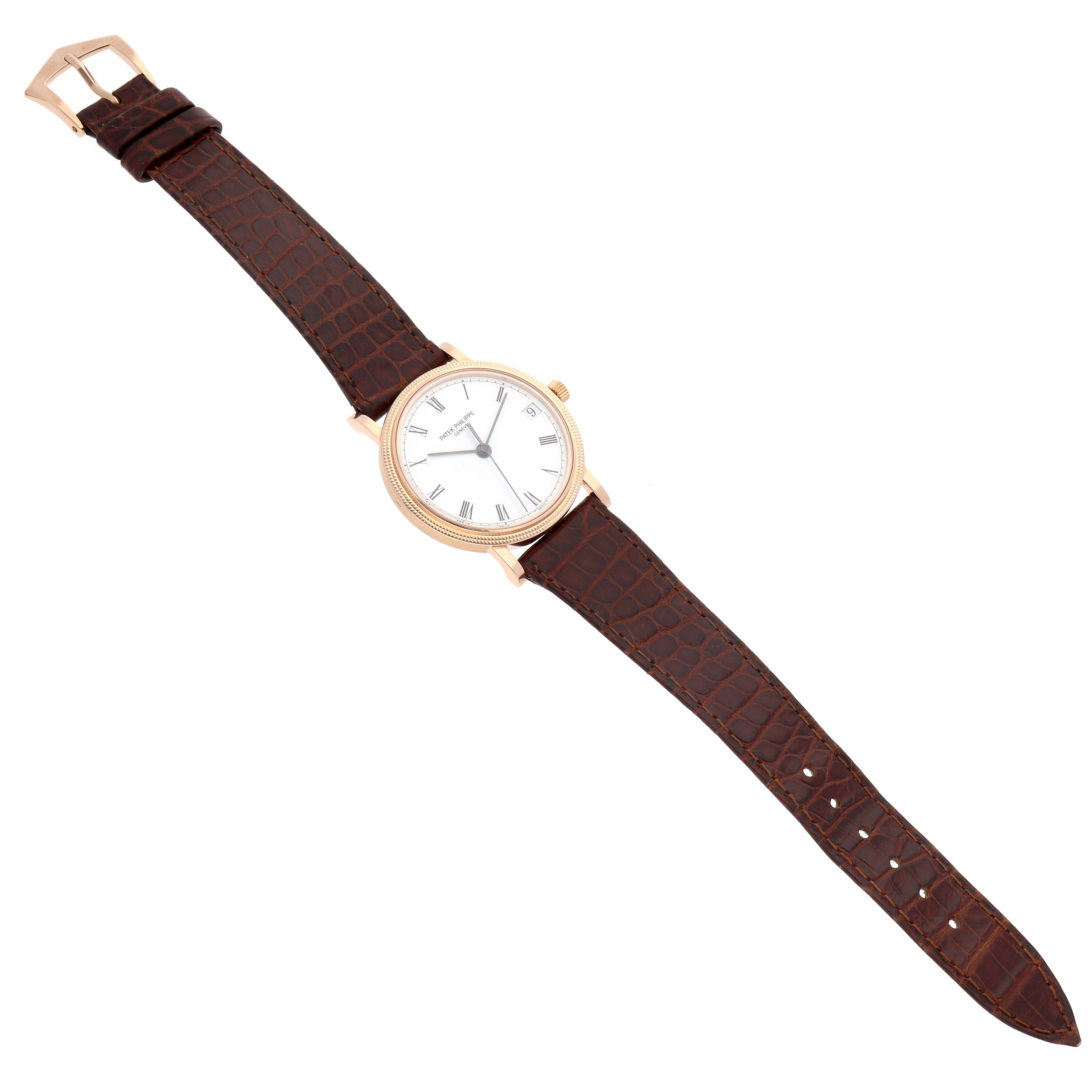 The Patek Philippe Calatrava 3802/200 Men's Rose Gold White Dial 3802/200 Men's Rose Gold White Dial watch is shown from a top-down angle, displaying the face and full leather strap.