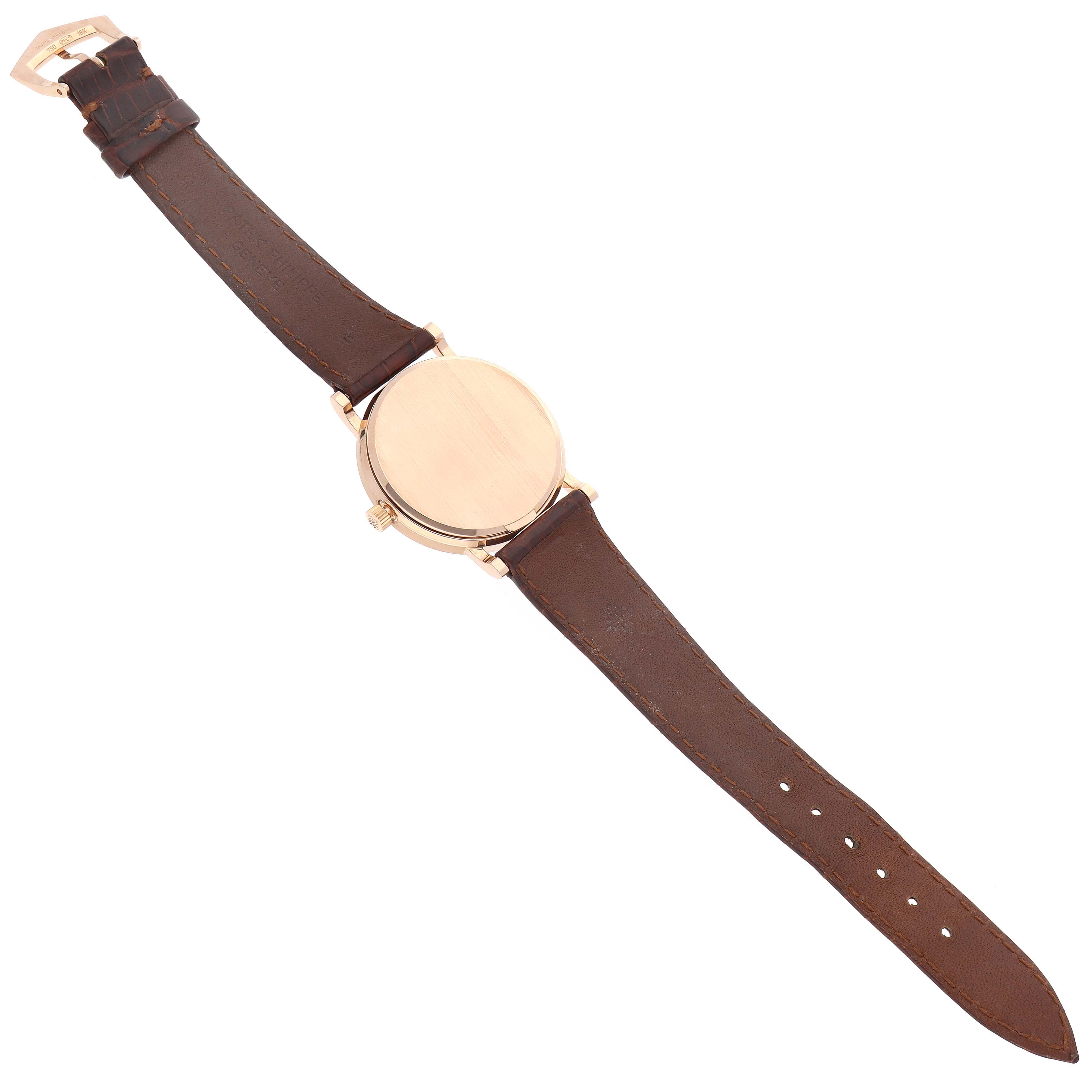 This Patek Philippe Calatrava 3802/200 Men's Rose Gold White Dial 3802/200 Men's Rose Gold White Dial watch is shown from the back, displaying the leather strap and case back.