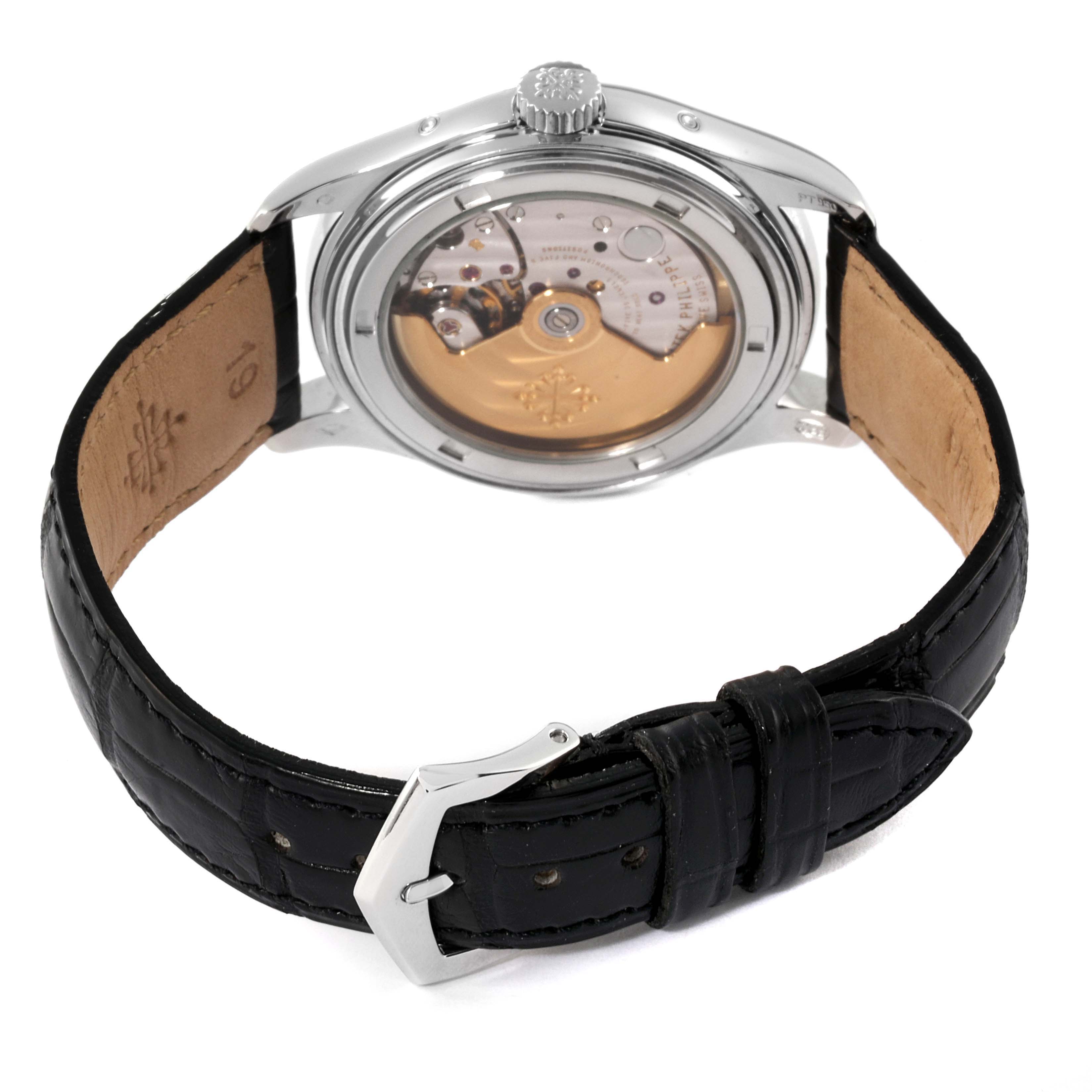 The image shows the back view of the Patek Philippe Complications 5035P Men's Platinum Black Dial 5035P Men's Platinum Black Dial model, highlighting its movement and black leather strap.