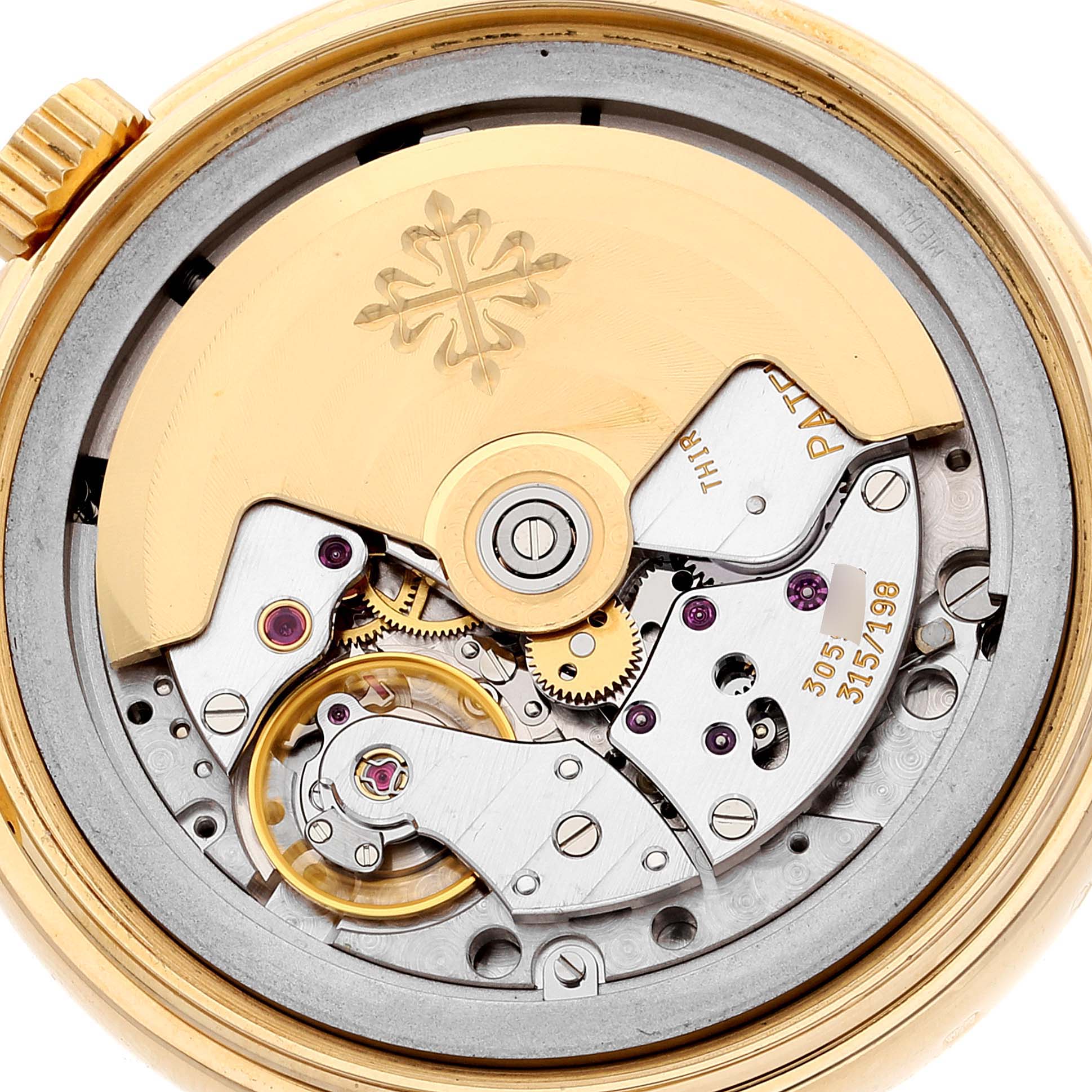 The image shows the movement and inner mechanics of a Patek Philippe Complications 5035G Men's Yellow Gold Silver Dial 5035G Men's Yellow Gold Silver Dial watch from a rear angle.