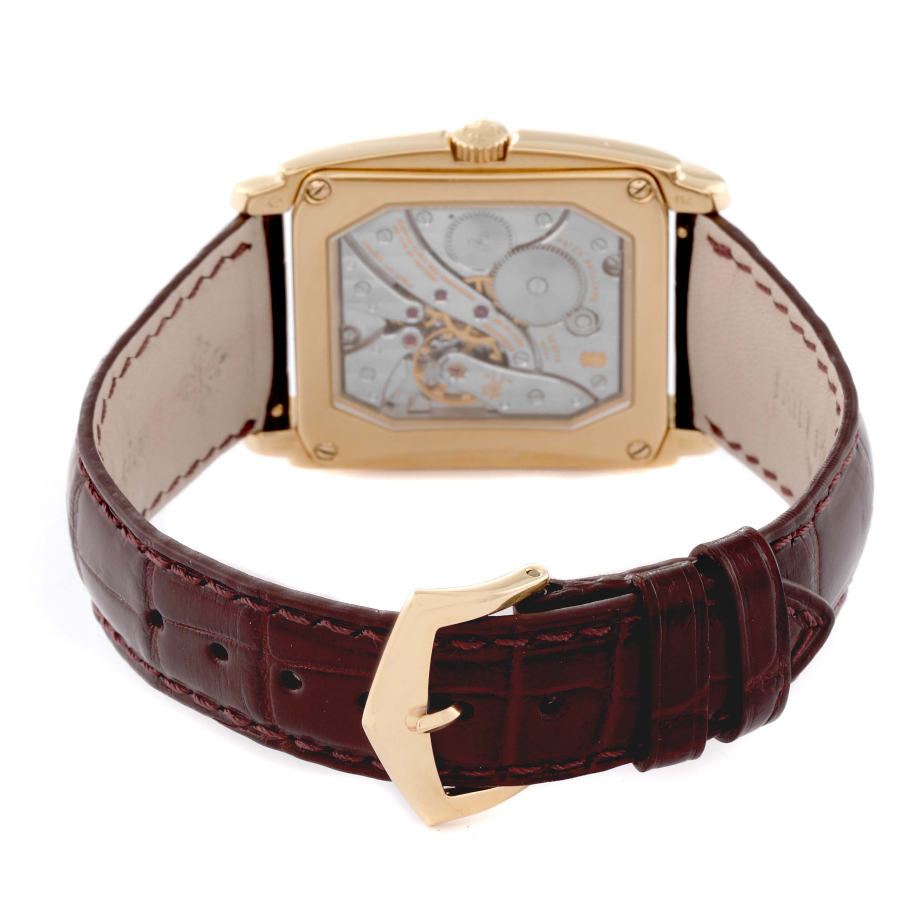 The image shows the back view of a Patek Philippe Gondolo 5124J Men's Yellow Gold Silver Dial 5124J Men's Yellow Gold Silver Dial watch, highlighting the movement through a transparent case and brown leather strap.