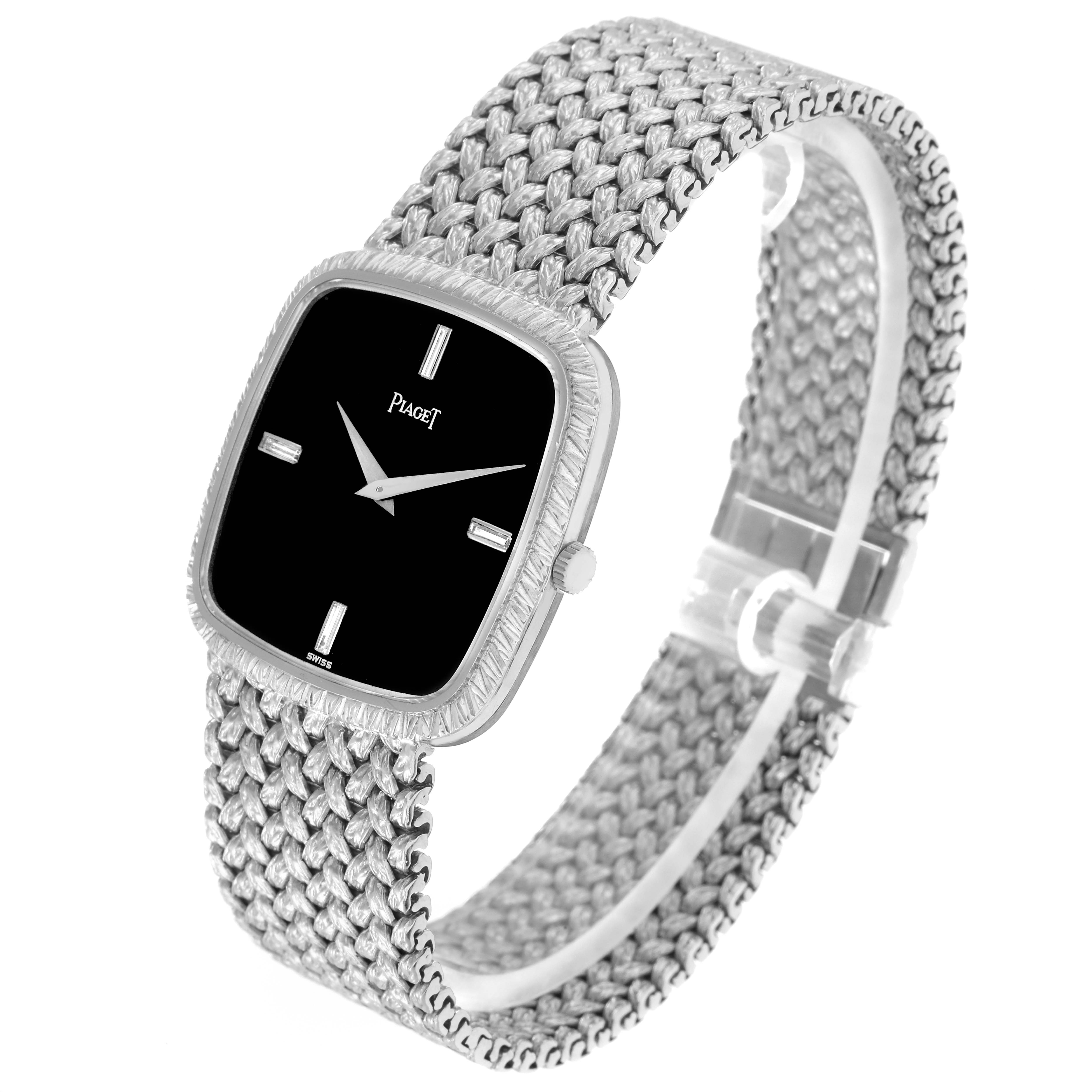 The Piaget model 9771D2 watch is shown from a three-quarter angle, displaying its black dial, textured bezel, and woven bracelet.