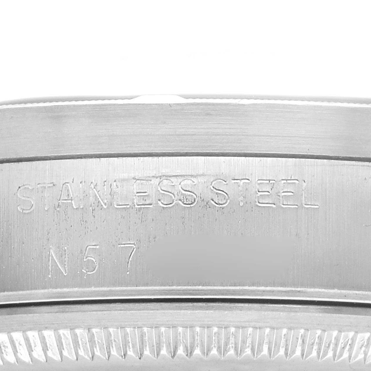 The image shows a close-up of the stainless steel bezel engraving on a Rolex Air-King, model number 14010, highlighting the edge details.