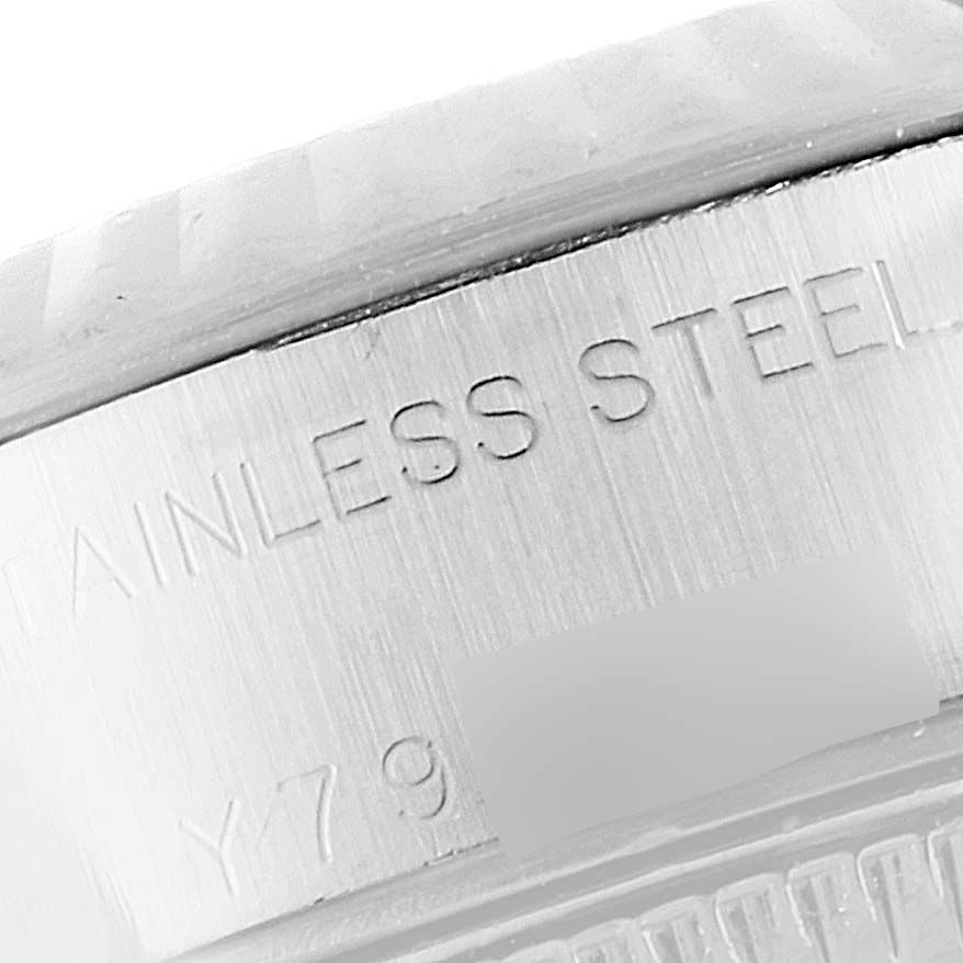 This close-up shows the stainless steel engraving on the case back edge of a Rolex Datejust 79174 Women
s Stainless Steel Silver Dial 79174 Women
s Stainless Steel Silver Dial watch.