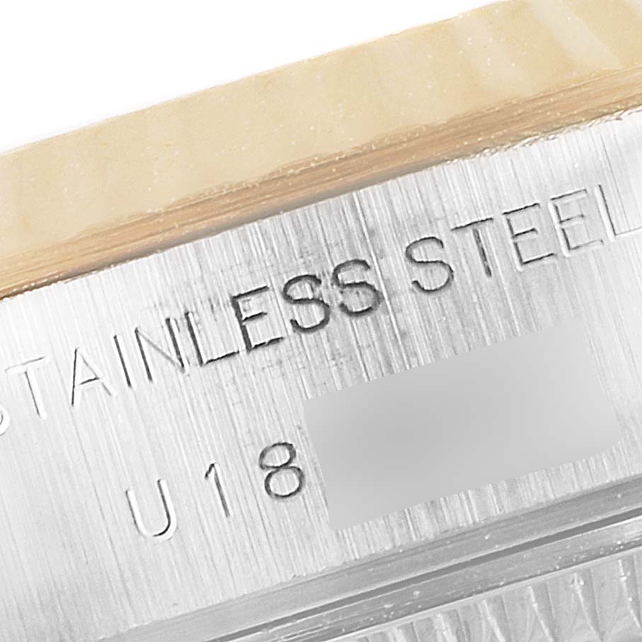 This close-up image of the Rolex Datejust 69173 Women's Steel and Gold (two tone) Blue Dial 69173 Women's Steel and Gold (two tone) Blue Dial watch shows the engraved detail on the stainless steel case.