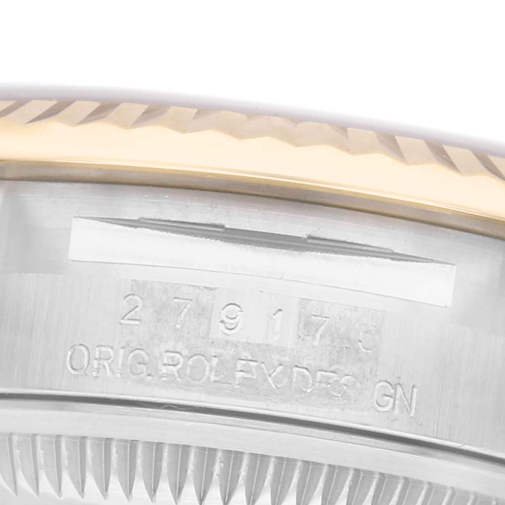 The image shows a close-up of the side of a Rolex Datejust model 279173, featuring the fluted bezel and engraved markings on the case.