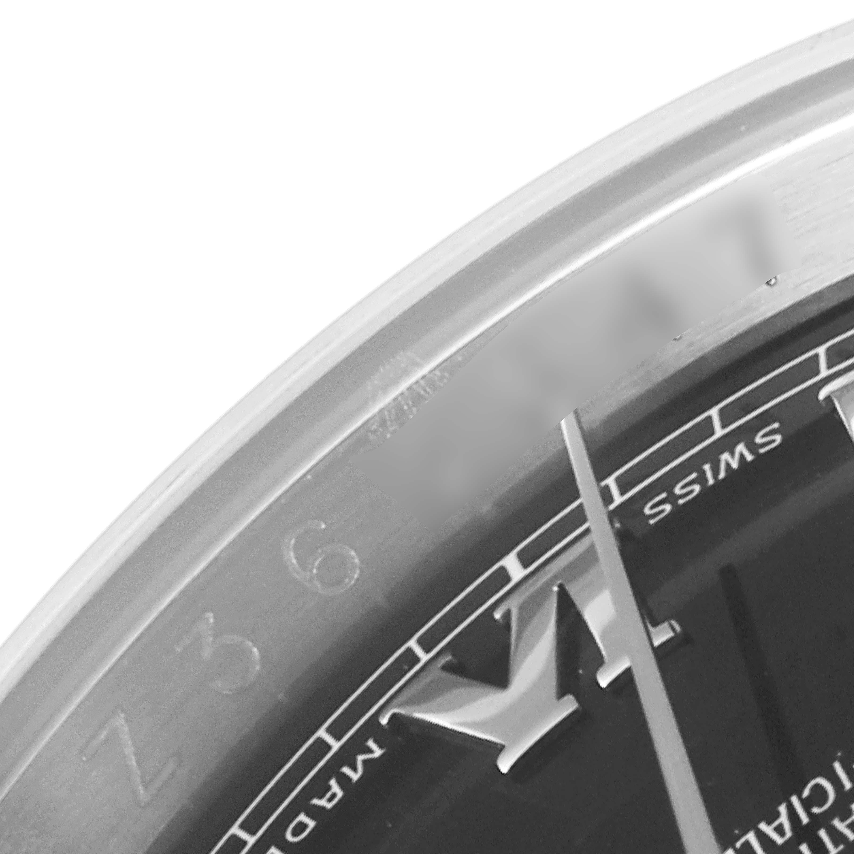 The close-up image shows the bezel and part of the dial and hand of a Rolex Datejust 116200 Men
s Stainless Steel Black Dial 116200 Men
s Stainless Steel Black Dial watch.