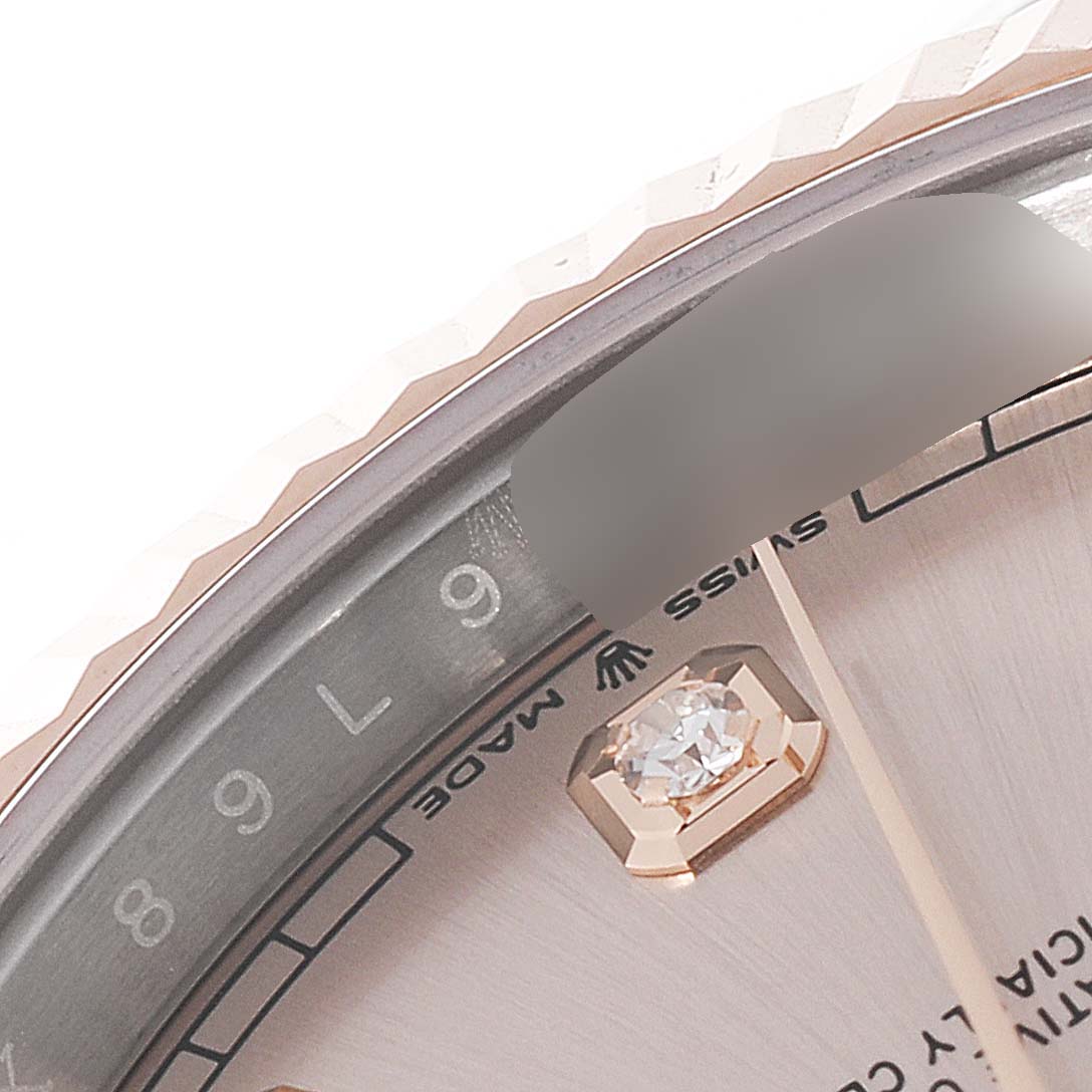 This close-up of the Rolex Datejust 41 126331 Men's Steel and Gold (two tone) Beige Dial 126331 Men's Steel and Gold (two tone) Beige Dial watch shows part of the bezel, dial, and a diamond hour marker.